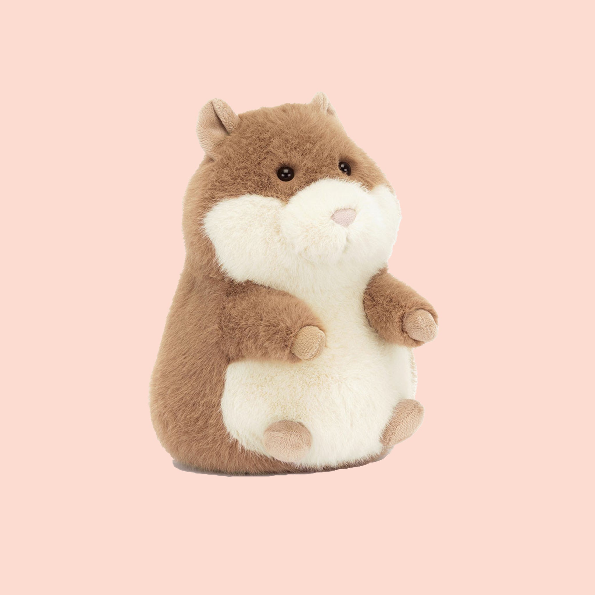 A tan and white stuffed animal guinea pig toy. 