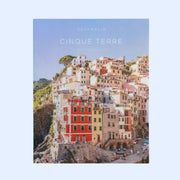 A puzzle box that looks like a book cover with a photograph of a cliffside in Cinque Terre and text that reads, 'Gray Malin Cinque Terre'. 