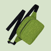 A green fanny pack with a black strap and zipper details. 