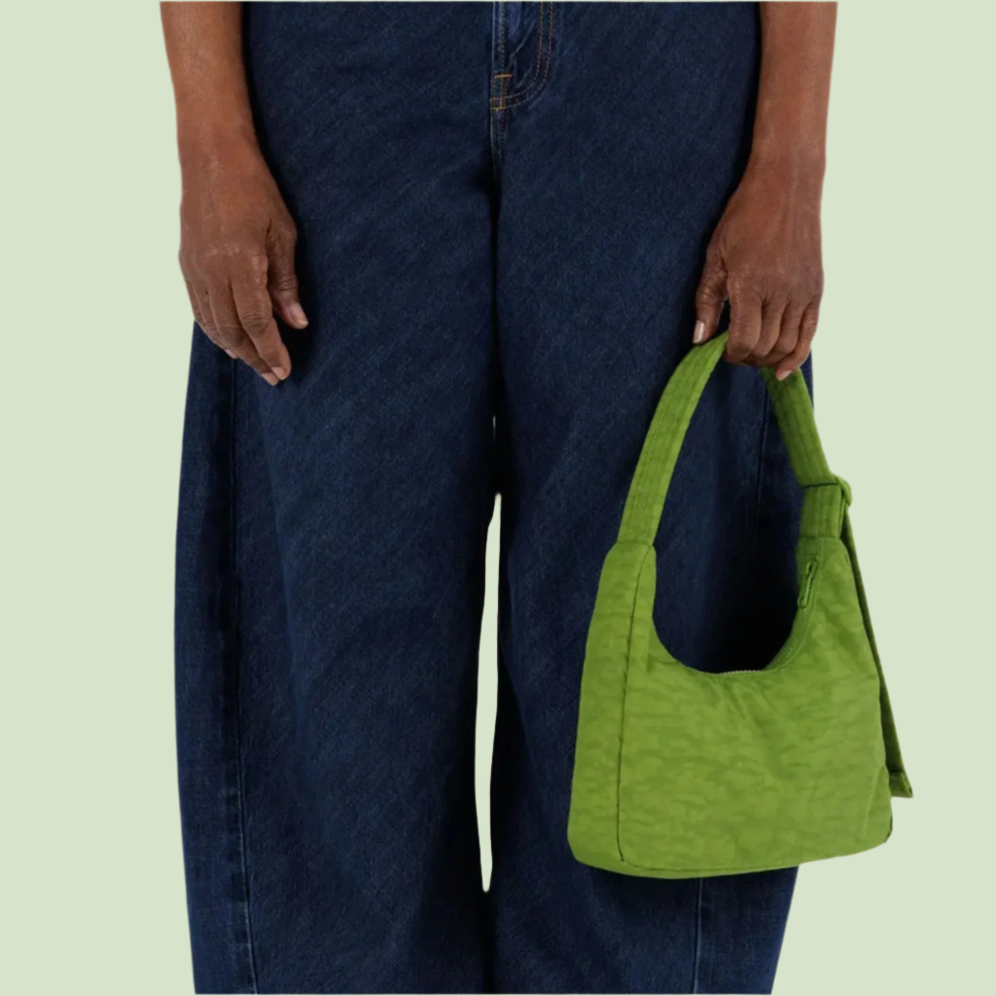 A green mini nylon shoulder bag. 