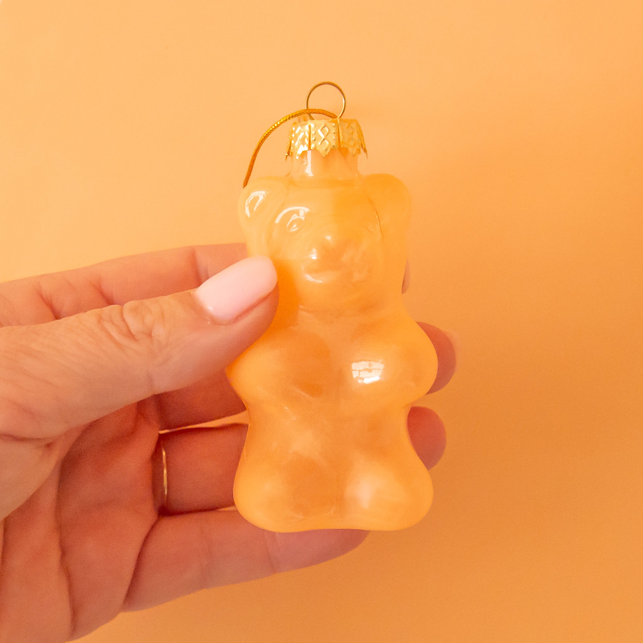 An orange gummy bear shaped ornament. 