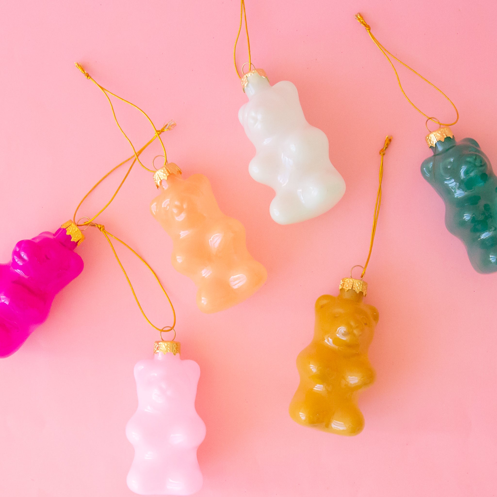 A variety of gummy bear shaped ornaments in different colors. 