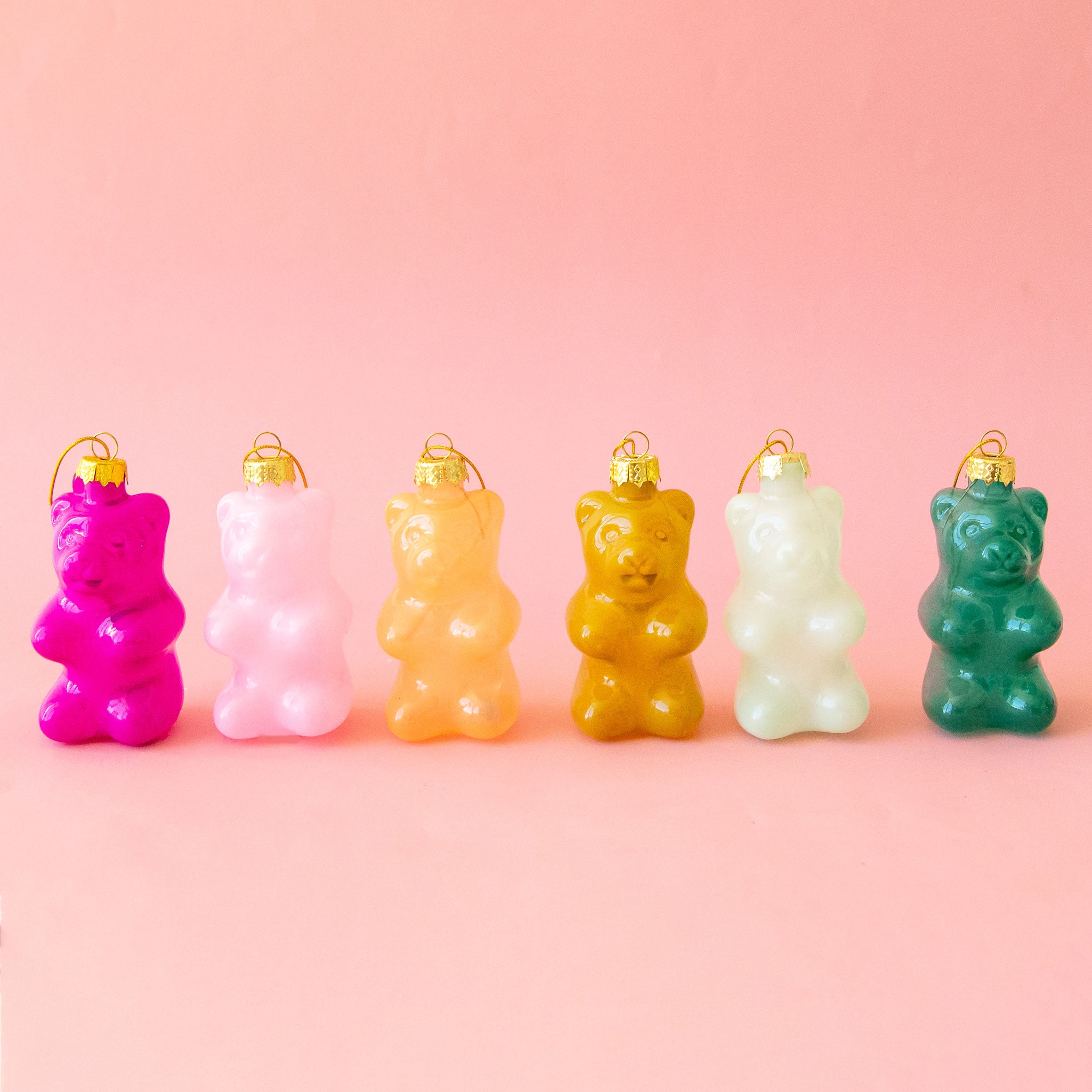 A variety of gummy bear shaped ornaments in different colors. 