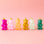 A variety of gummy bear shaped ornaments in different colors. 