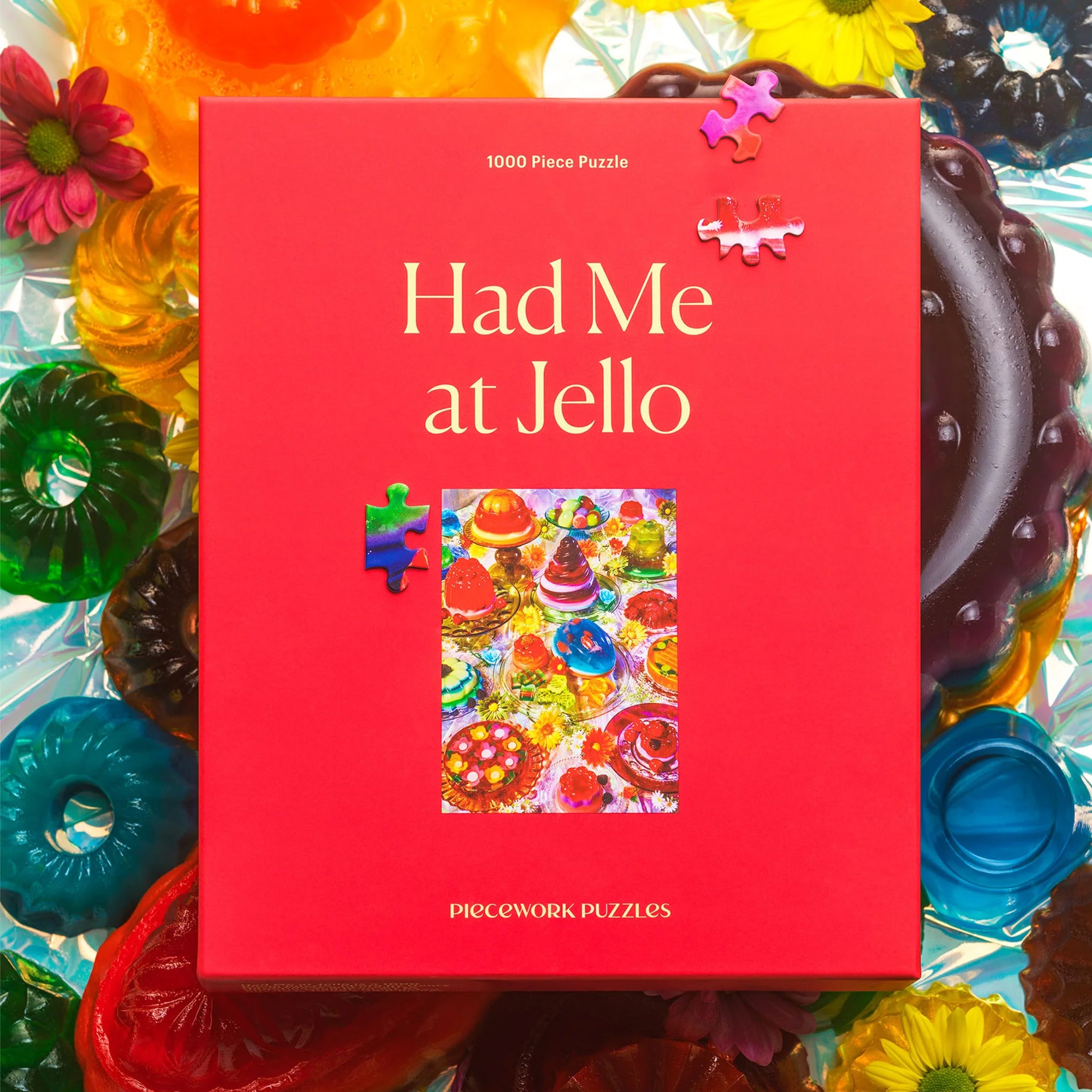 A red boxed puzzle with a colorful jello image and design and the title that reads, 'Had Me at Jello Piecework Puzzles'. 