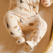 A neutral footie onesie with a Halloween icons pattern. 