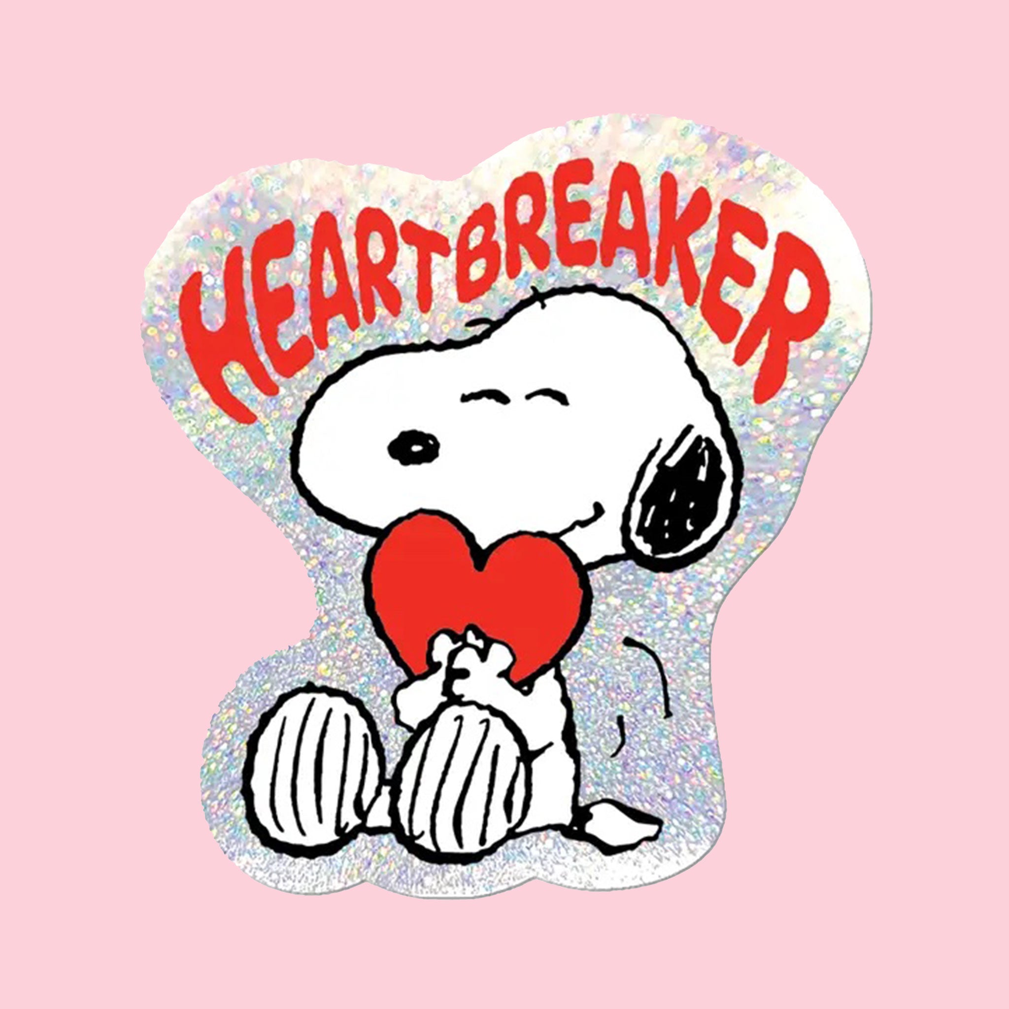 A silver and red sticker with a graphic of Snoopy holding a heart and text above that reads, 'Heartbreaker'. 