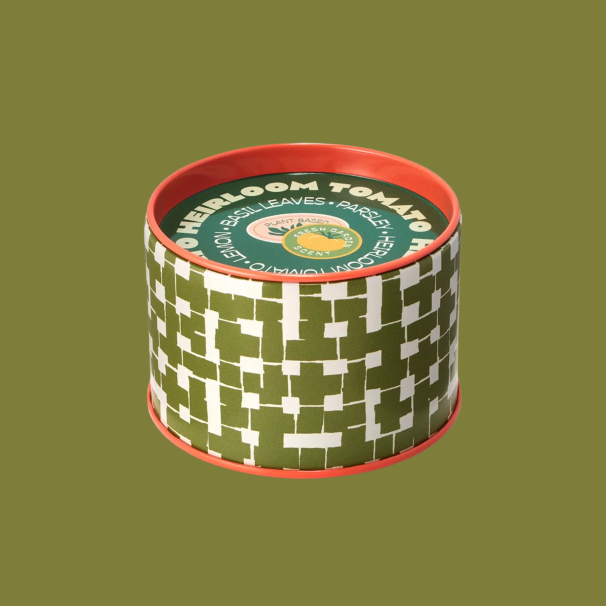 A green and white candle with a coral orange trim. 