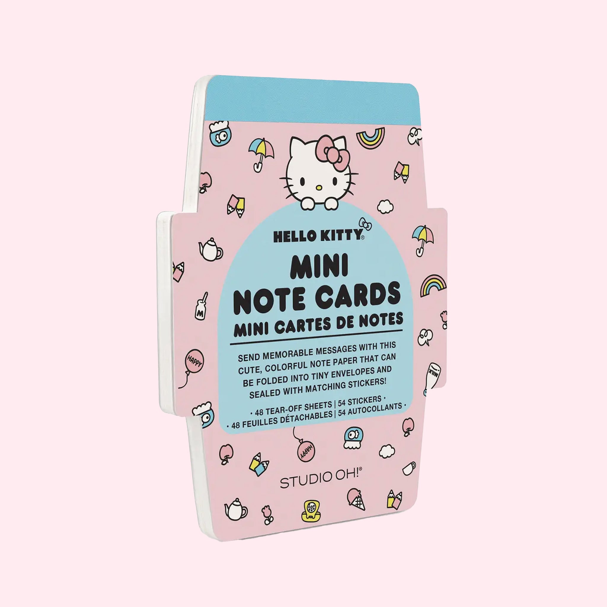 A pink and blue note card pad with hello kitty graphics on the front. 