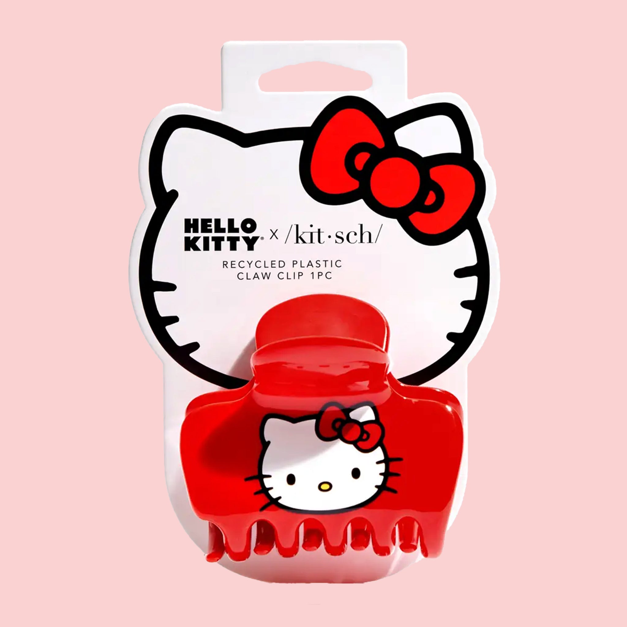 A red claw clip with a hello kitty fcae on the side.