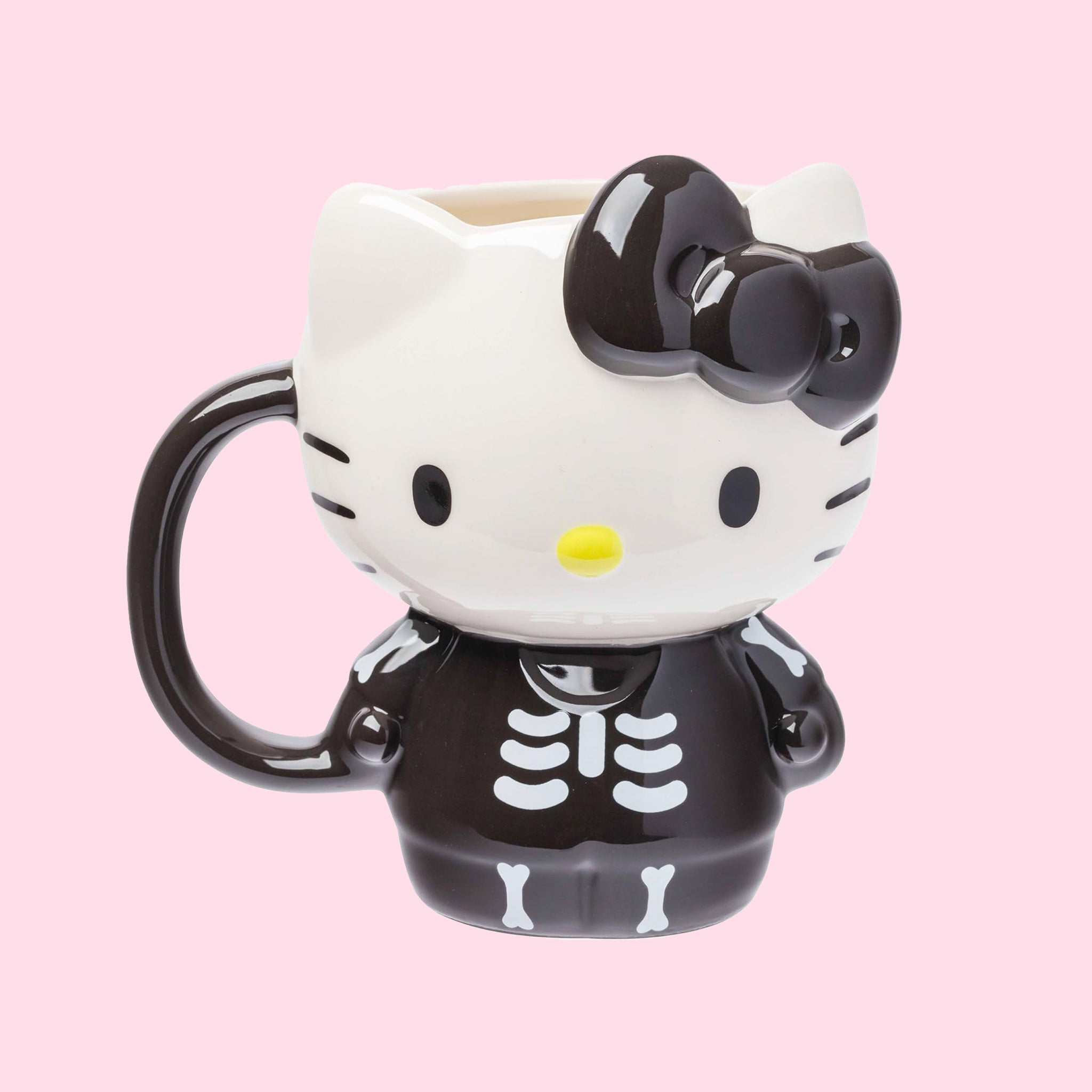 A black and white hello kitty shaped mug wearing a skeleton costume. 