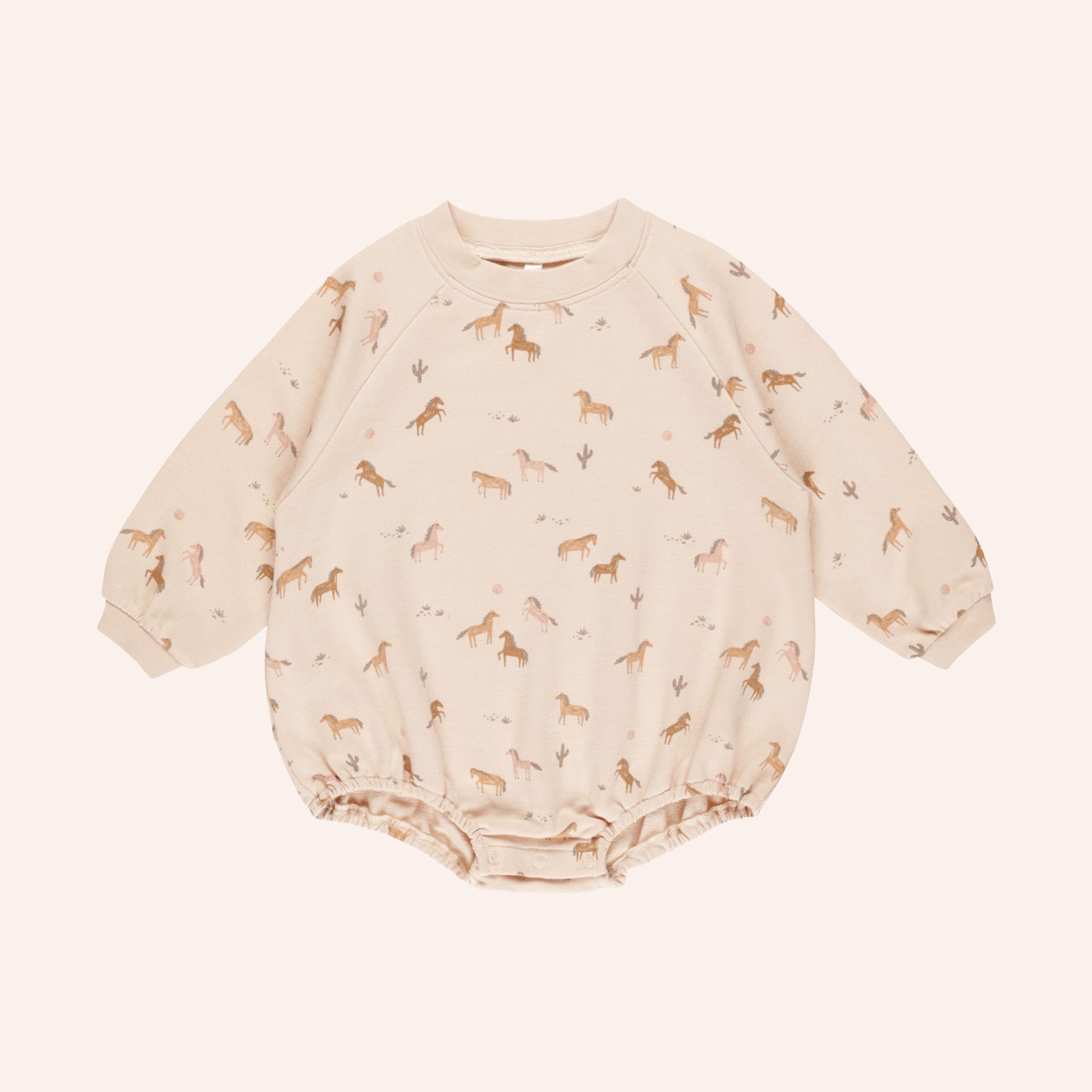 A light pink onesie crew neck with a subtle horse print.