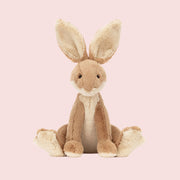 A tan rabbit shaped stuffed animal toy with big ears. 