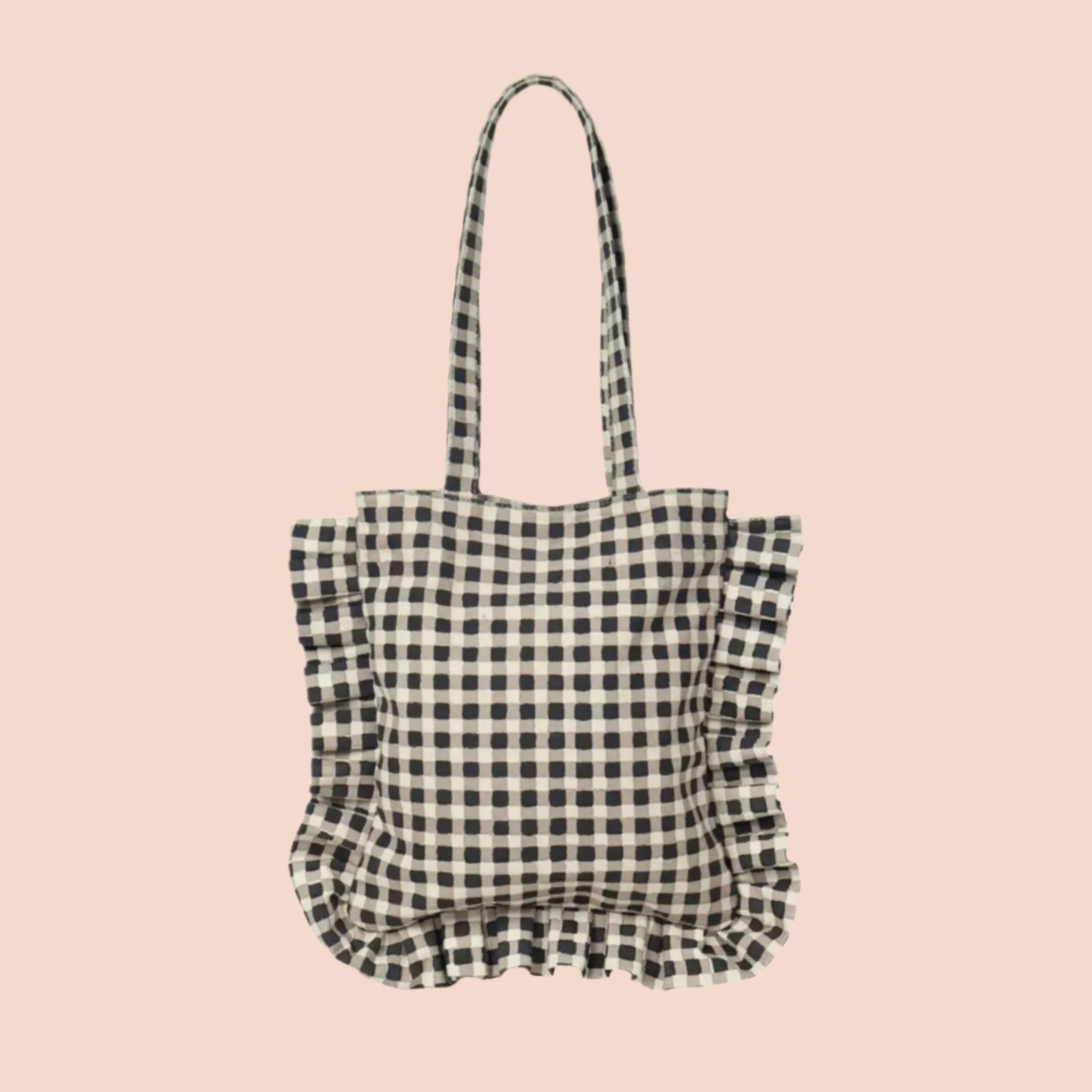 A black and white gingham print tote bag with ruffle details and shoulder straps. 