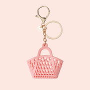 A bag shaped bag charm with a gold loop for attaching. 