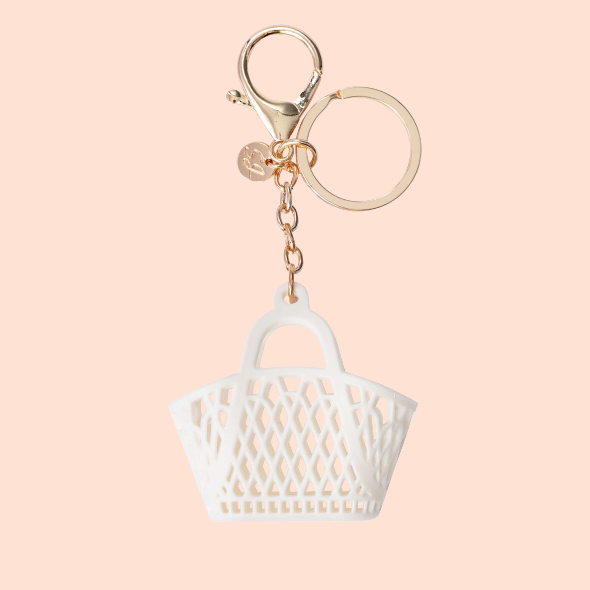 A small white bag shaped bag charm with a loop for attaching. 