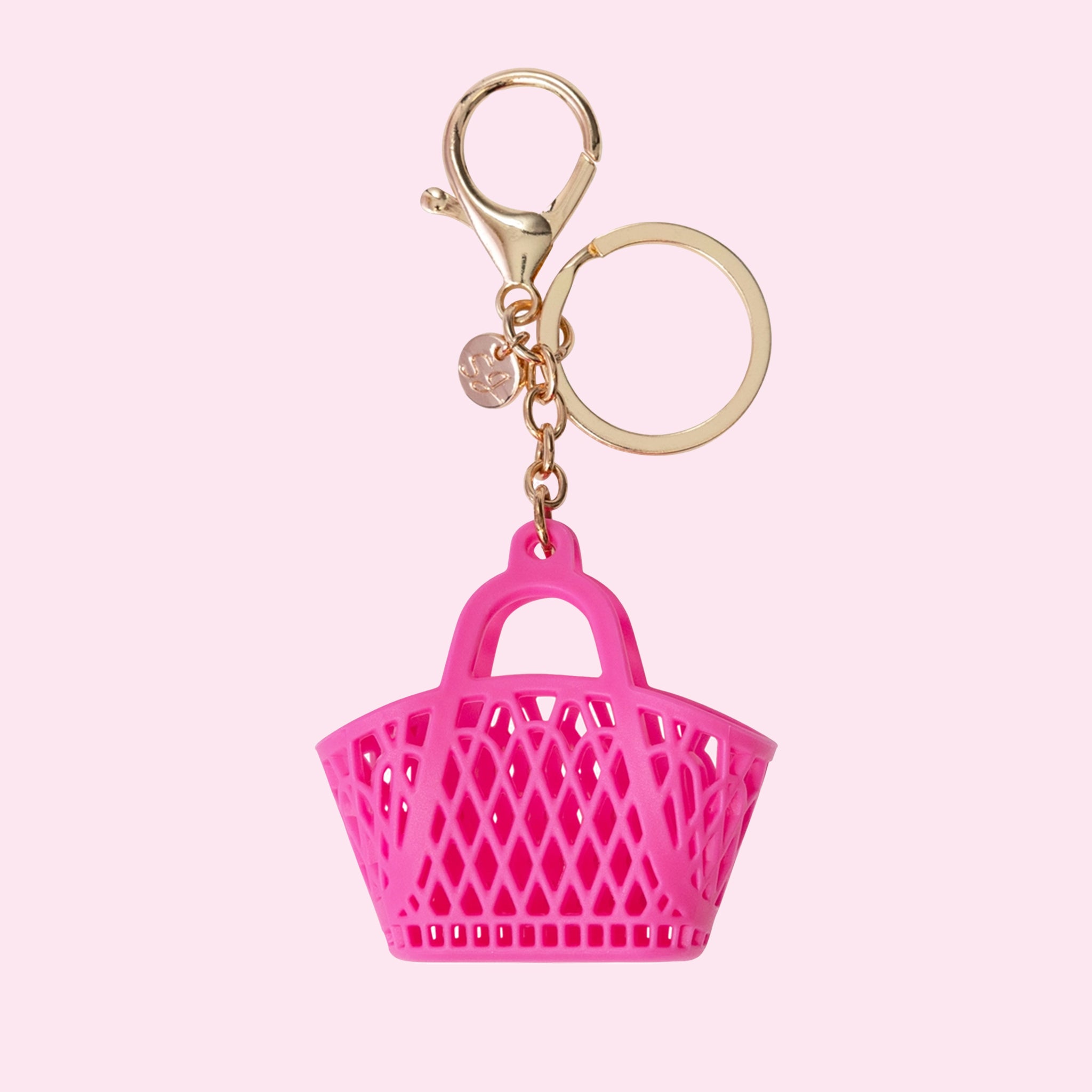 On a pink background is a hot pink jelly bag shaped bag charm. 