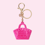 On a pink background is a hot pink jelly bag shaped bag charm. 