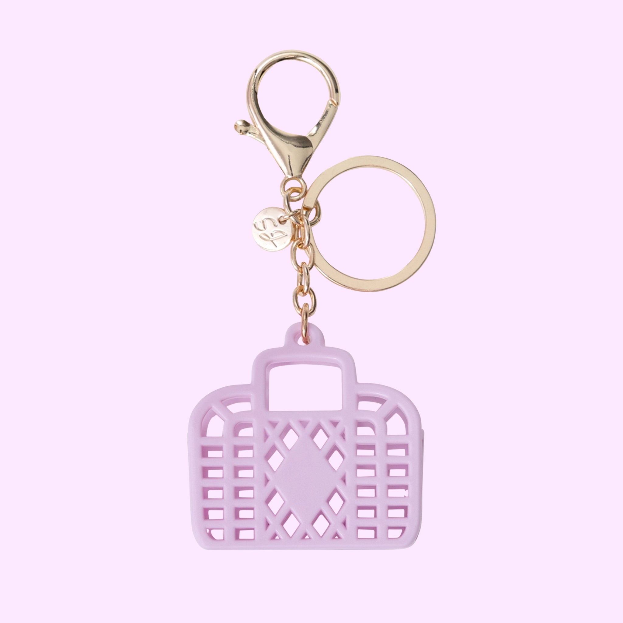 A lilac colored bag shaped mini bag charm. 