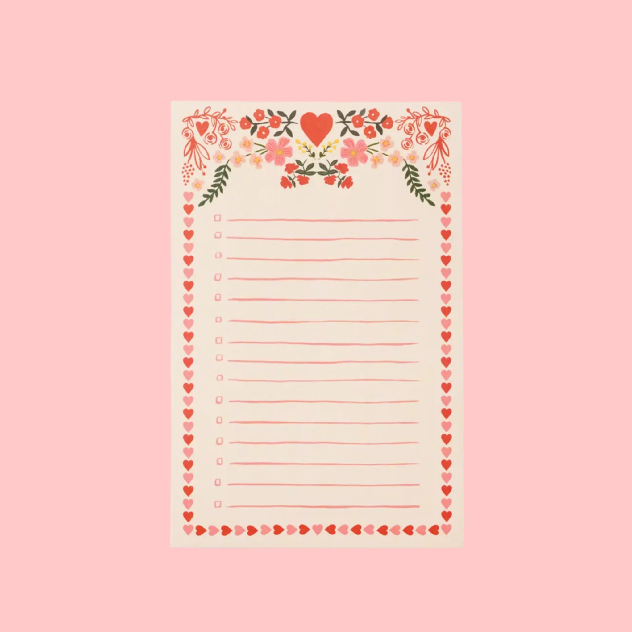 A light pink notepad with a red and pink heart and floral print and border. 