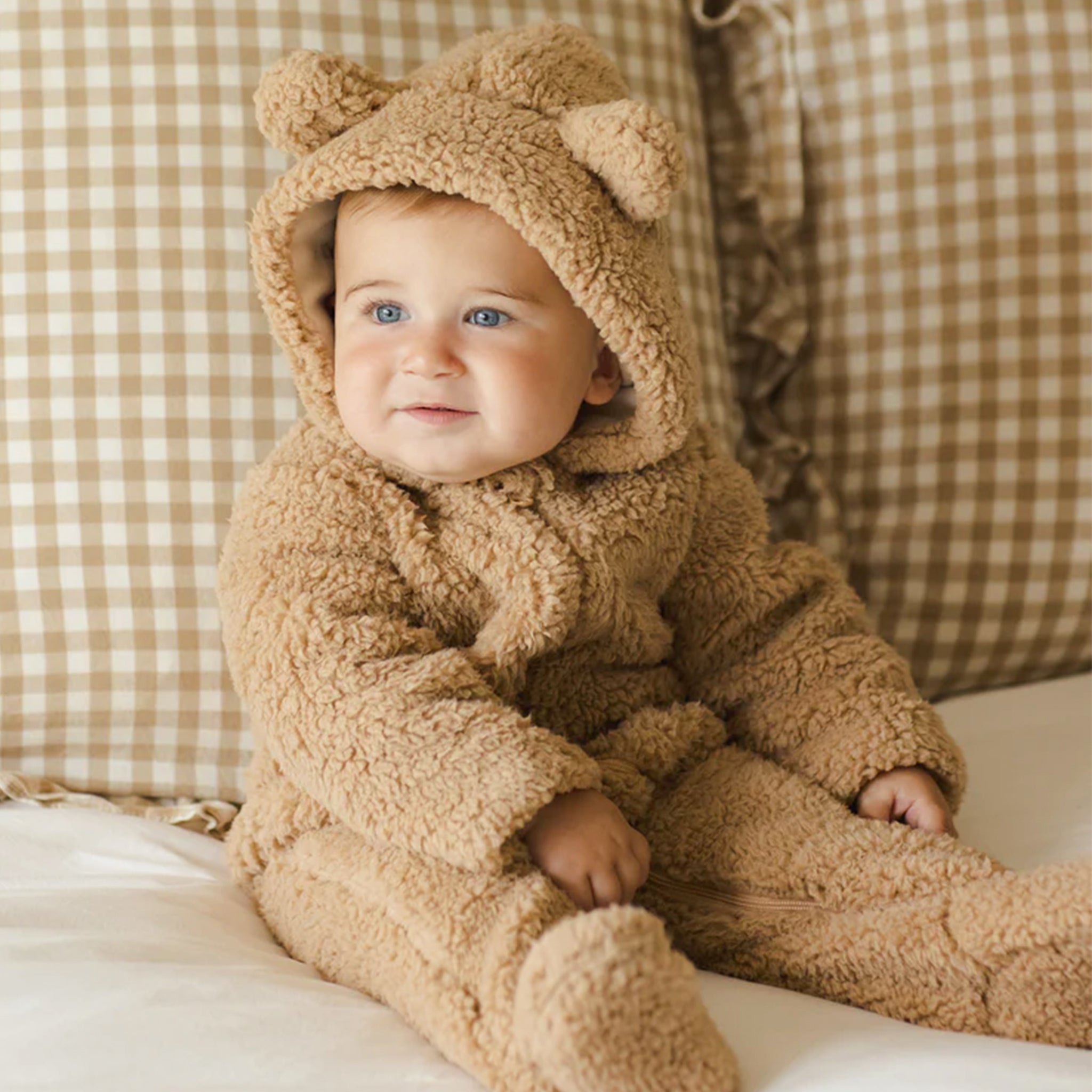 A fuzzy brown jumpsuit with a hood with bear ears on it. 