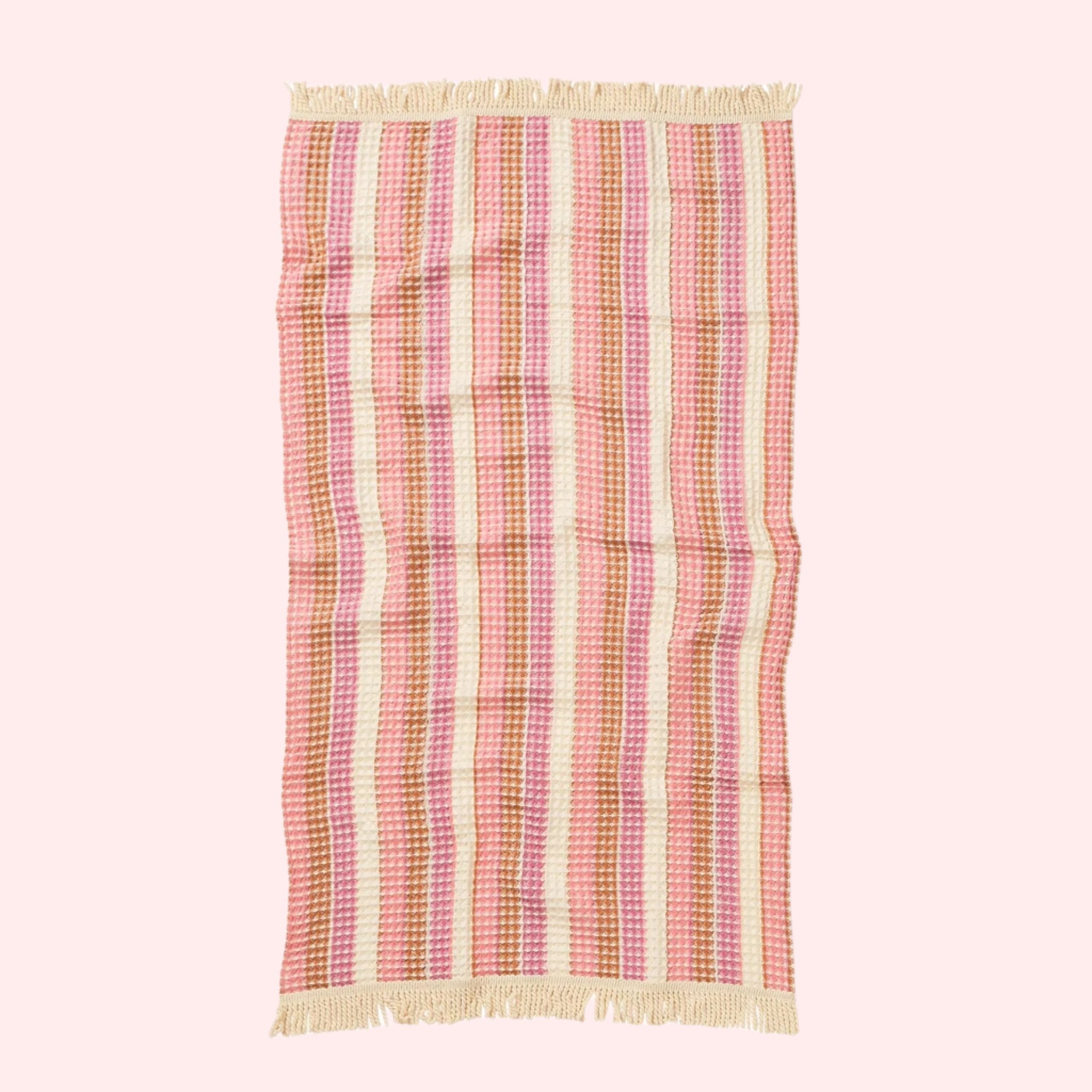 A pink striped waffle knit bath towel. 