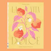 On an orange background is a yellow book cover with a fruit and foliage graphic with the title that reads, "La Vita E Dolce Italian Inspired Desserts". 