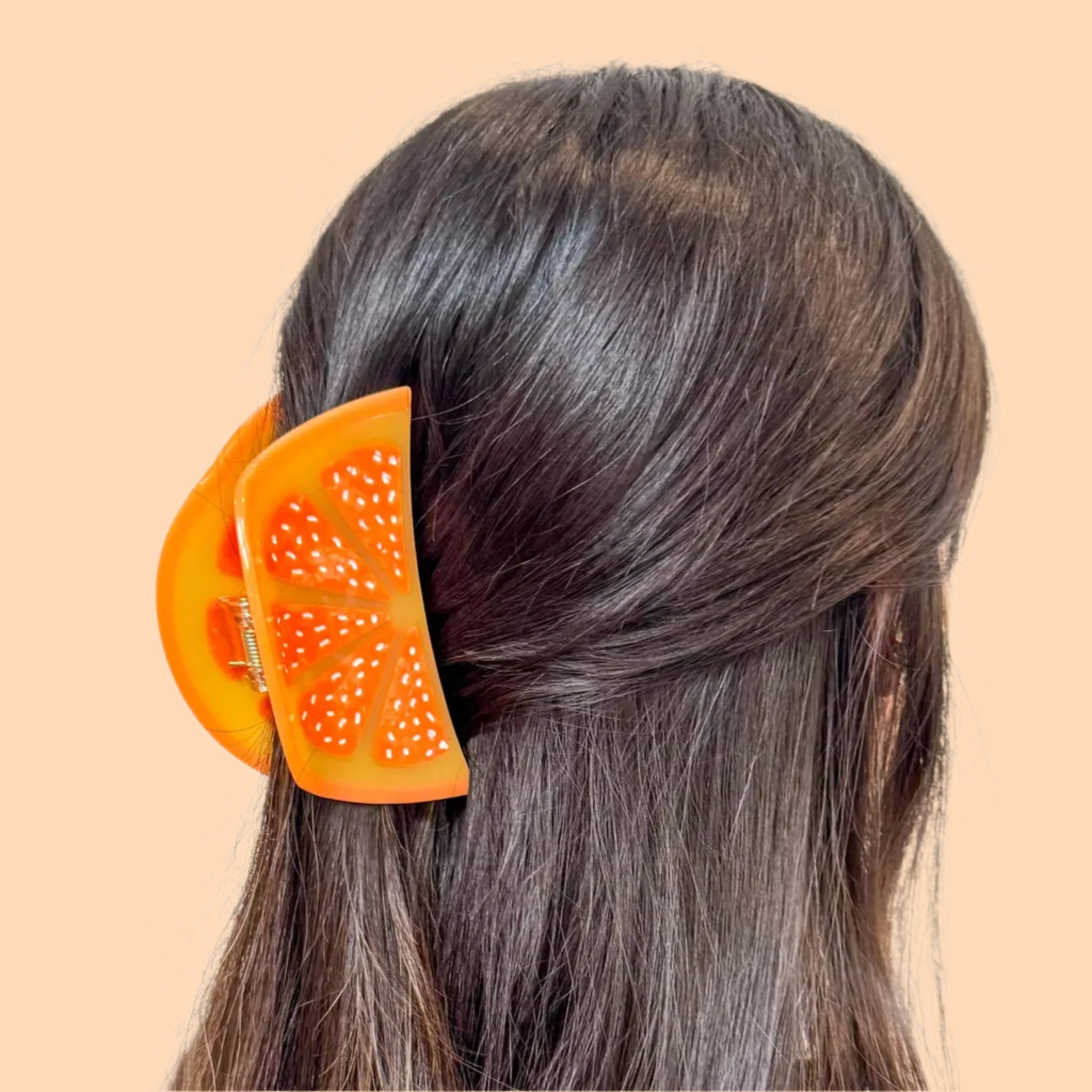 A large orange slice shaped hair claw clip.