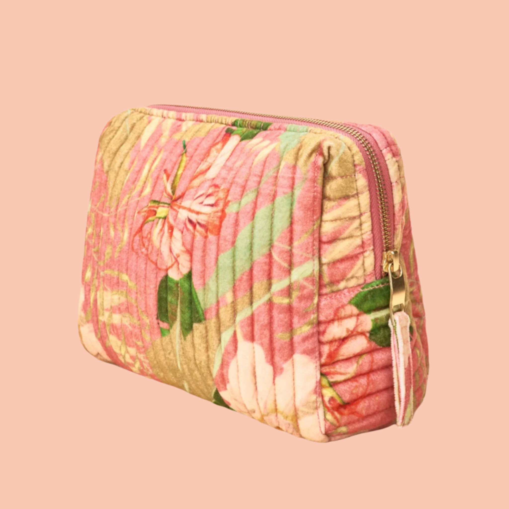 A coral and green floral patterned cosmetic pouch with a zipper closure. 