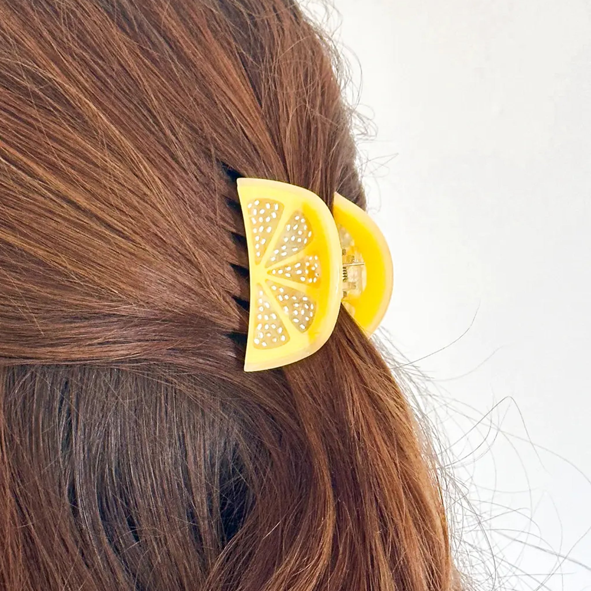 A mini lemon slice shaped hair claw clip. 