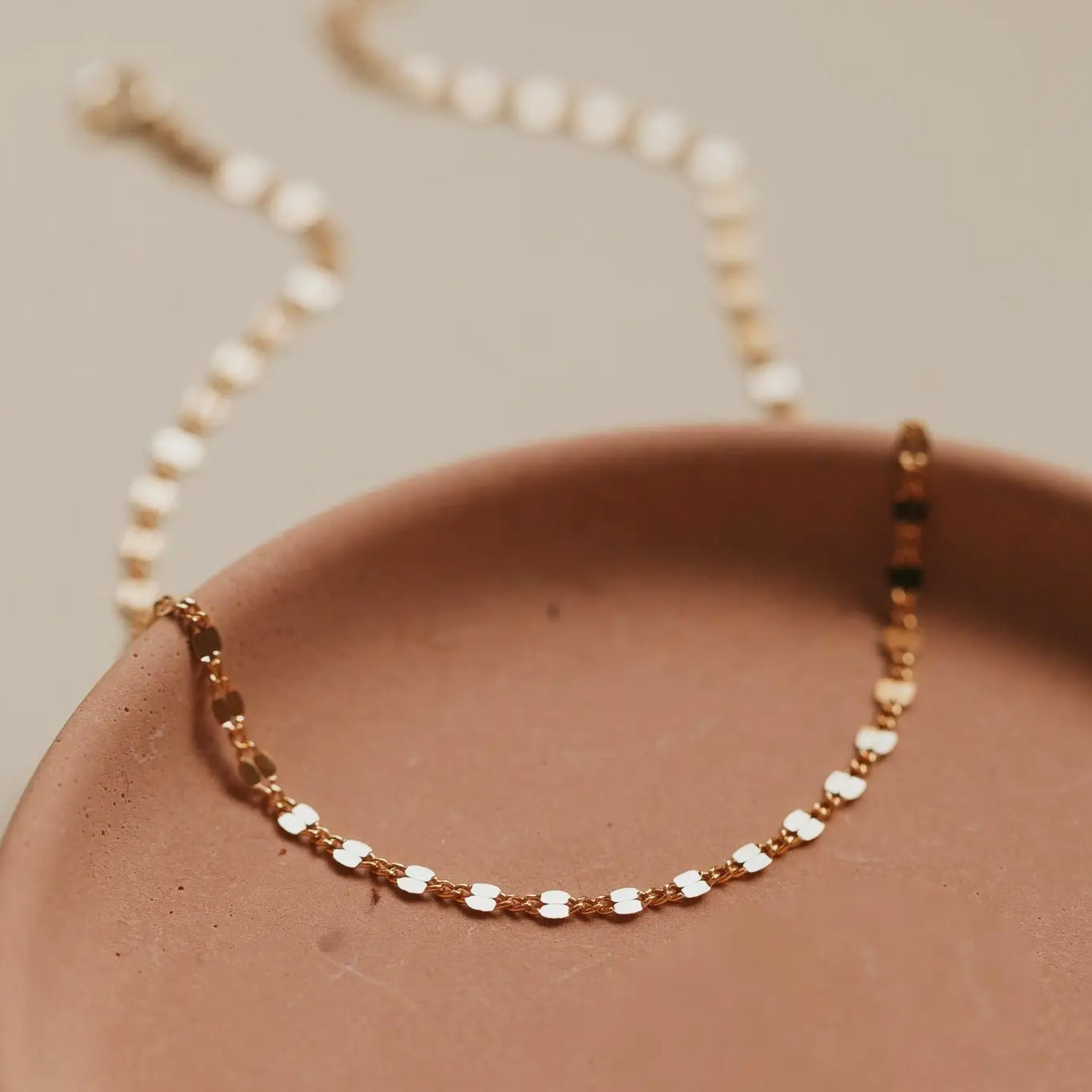 A gold chain anklet. 