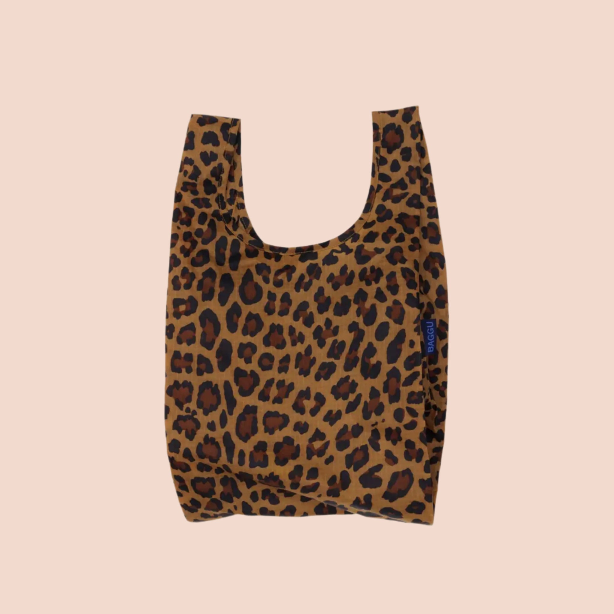 A small nylon tote bag in a leopard print that folds up into a small pouch. 