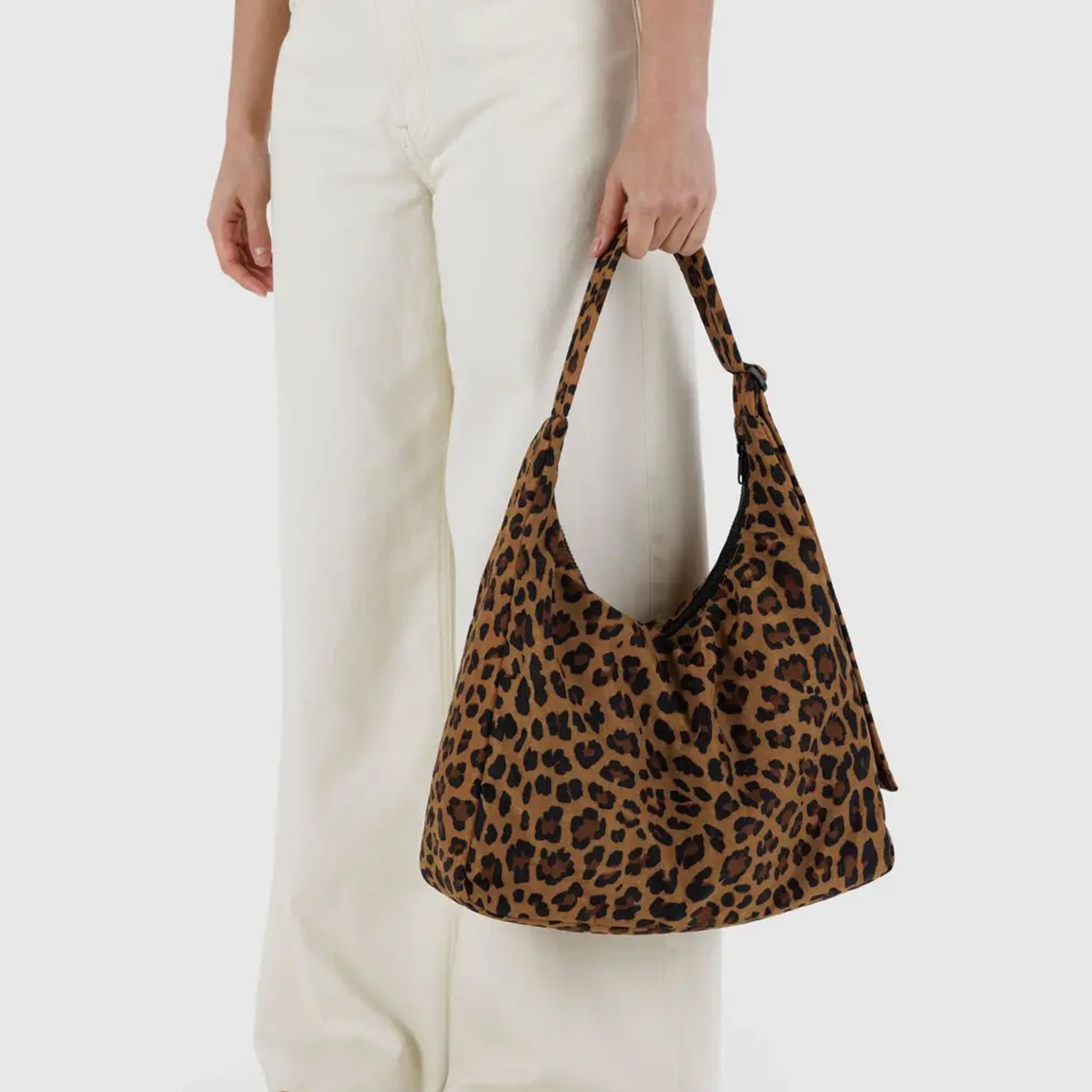 A nylon shoulder handbag with a leopard print pattern.