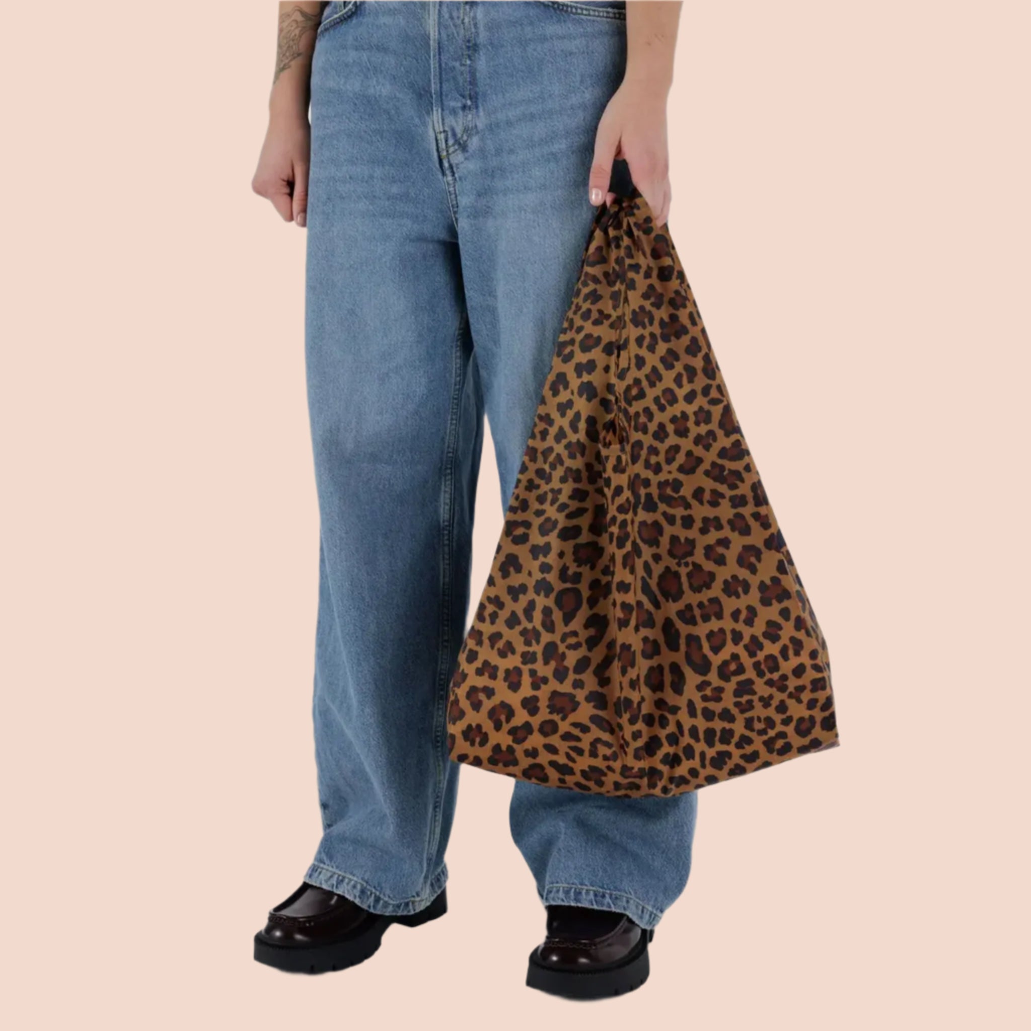 A nylon tote bag with a brown and black leopard print. 