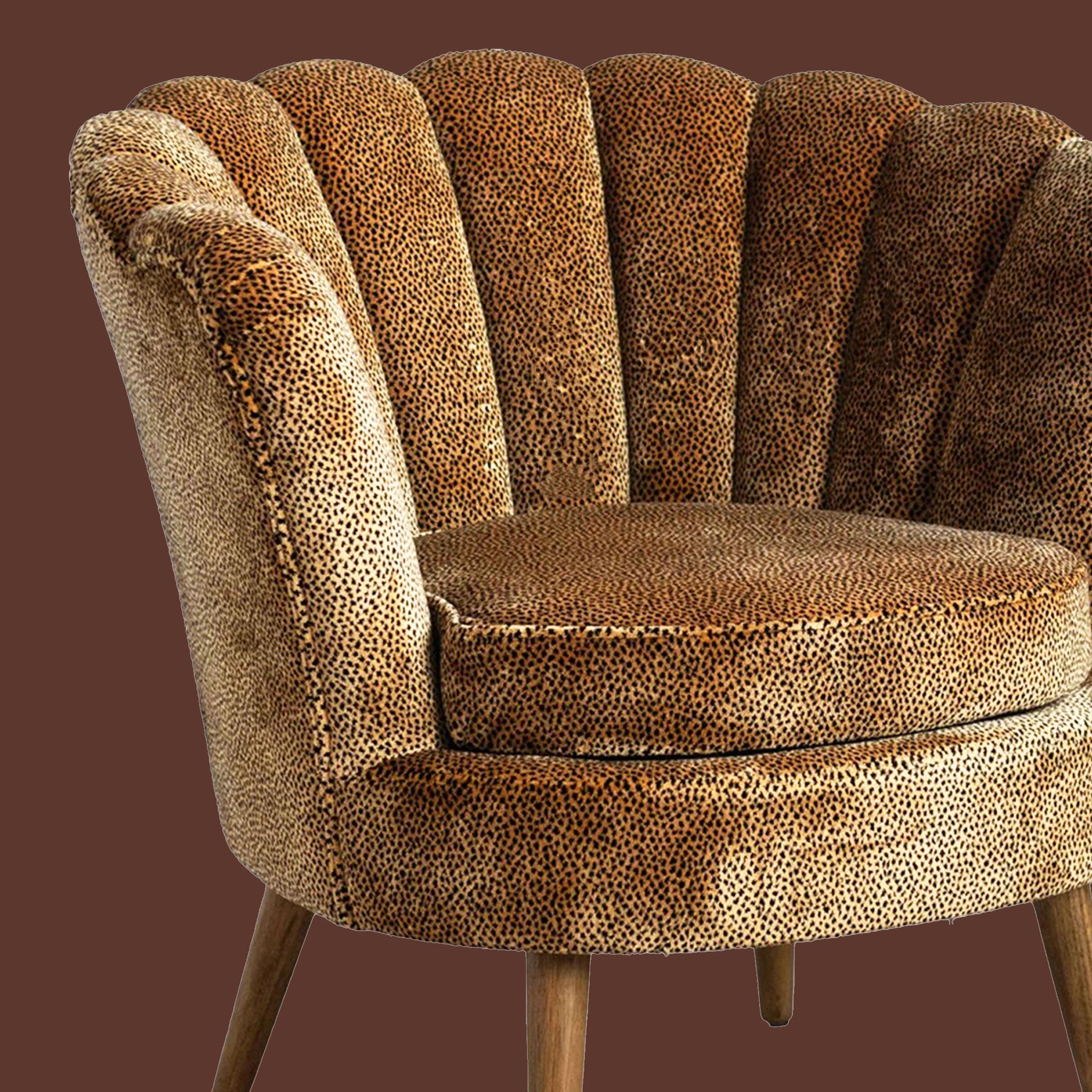 A leopard print accent chair with wood legs. 