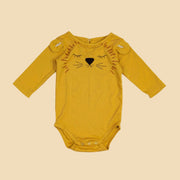 A long sleeve mustard onesie with a lion face in the center. 