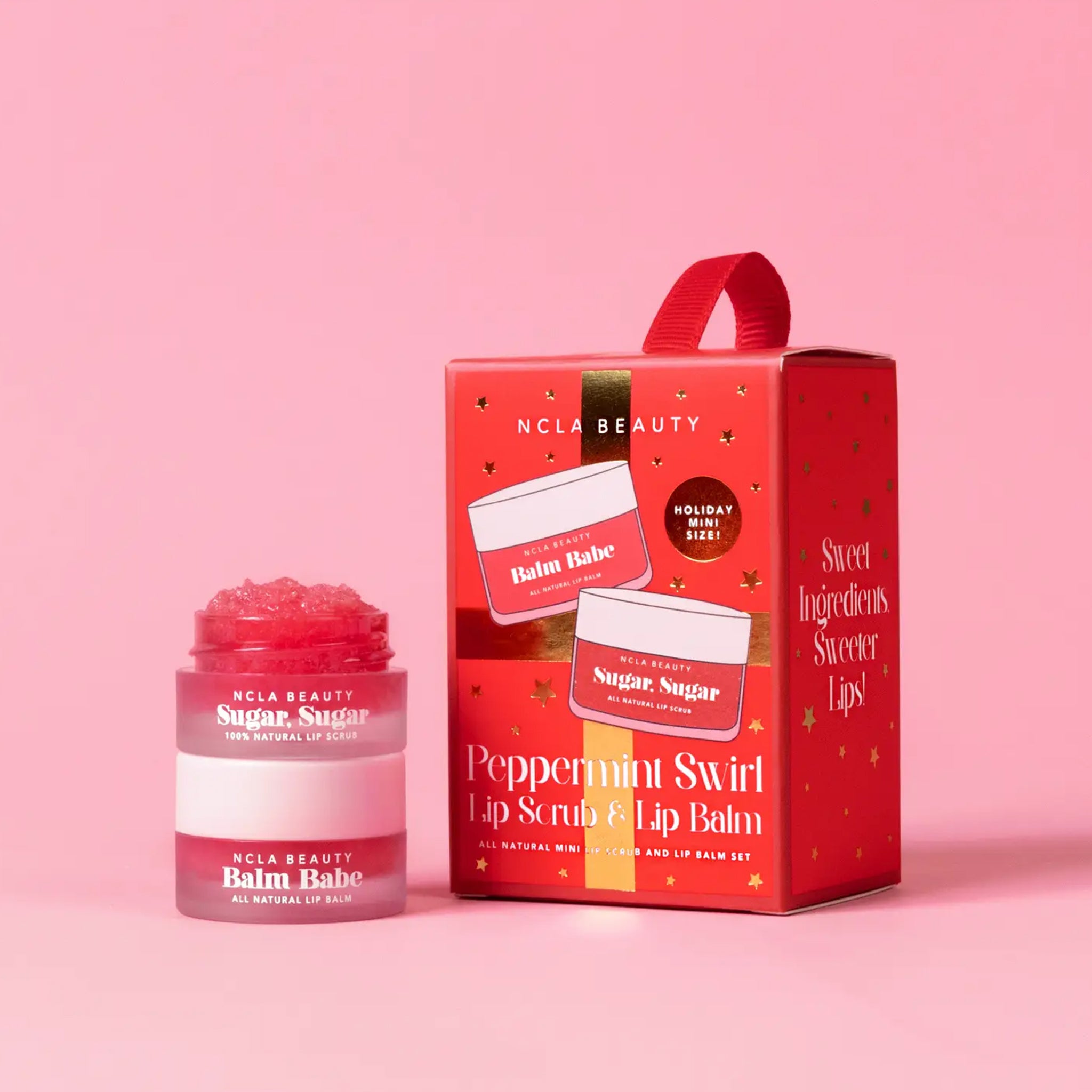 A set of one lip scrub and lip balm in a red package that is also a loop for hanging on a tree. 
