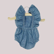 A denim romper with a ruffle sleeve detail. 