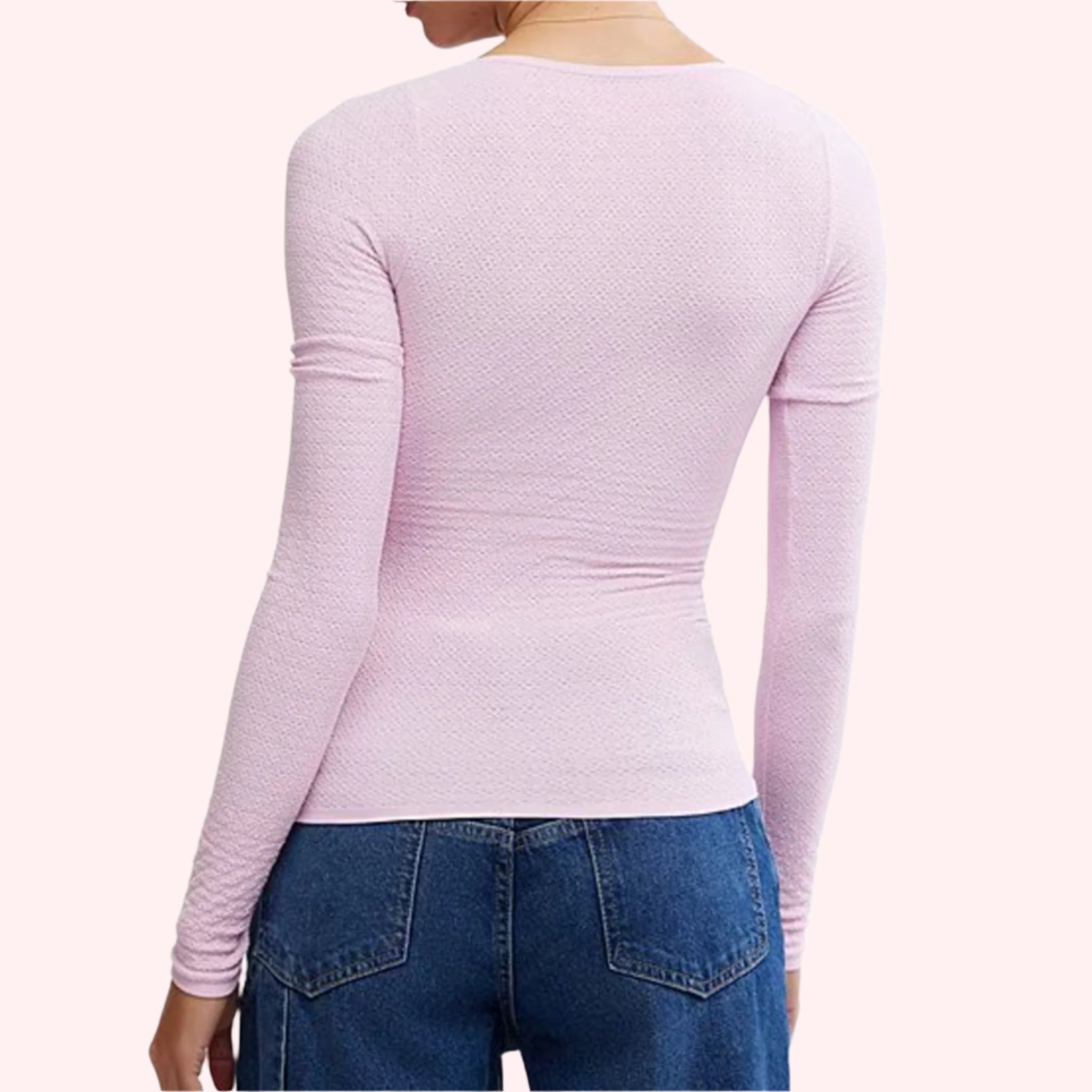 A pink long sleeve scoop neck shirt with a subtle texture. 