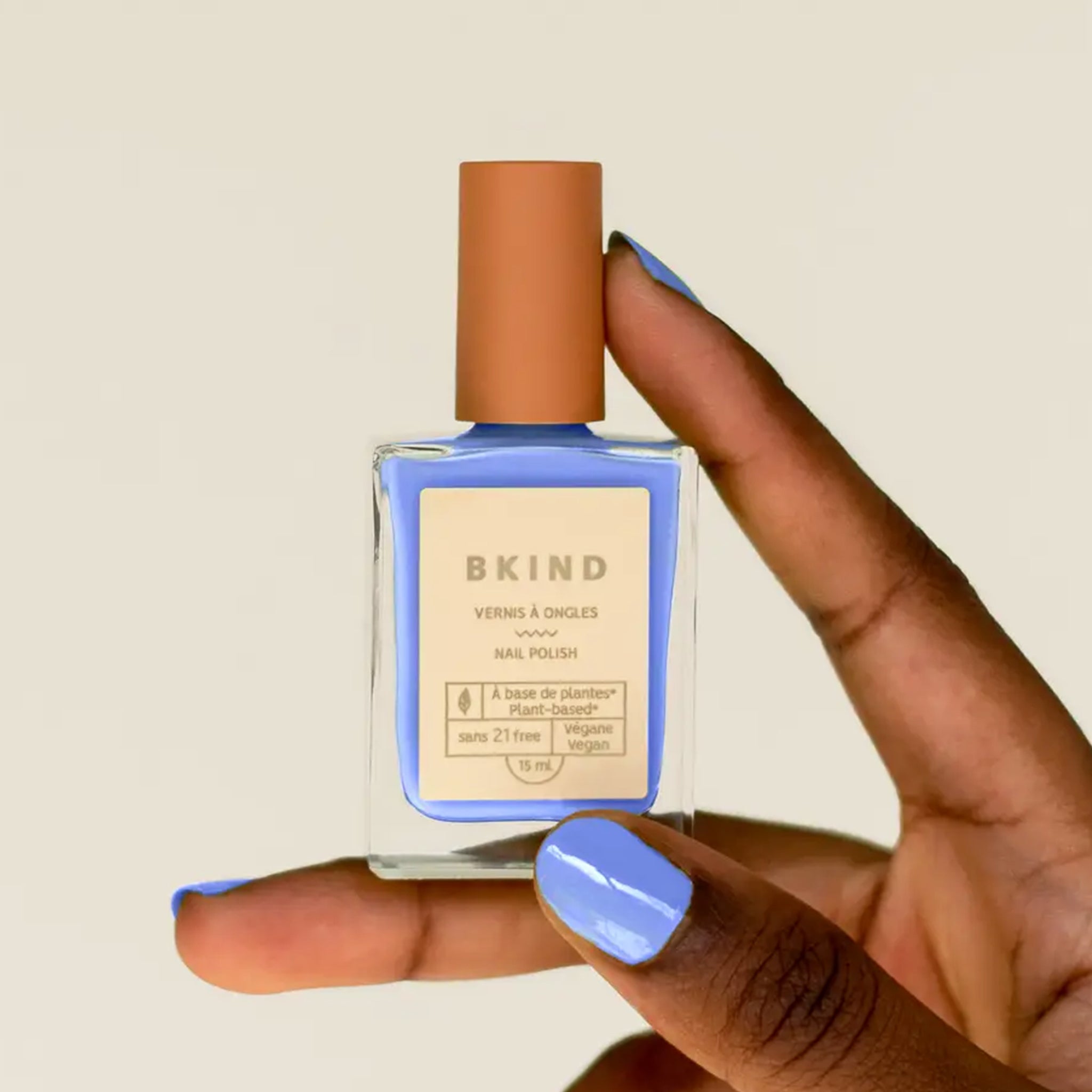 A blue nail polish in rectangle glass bottle. 