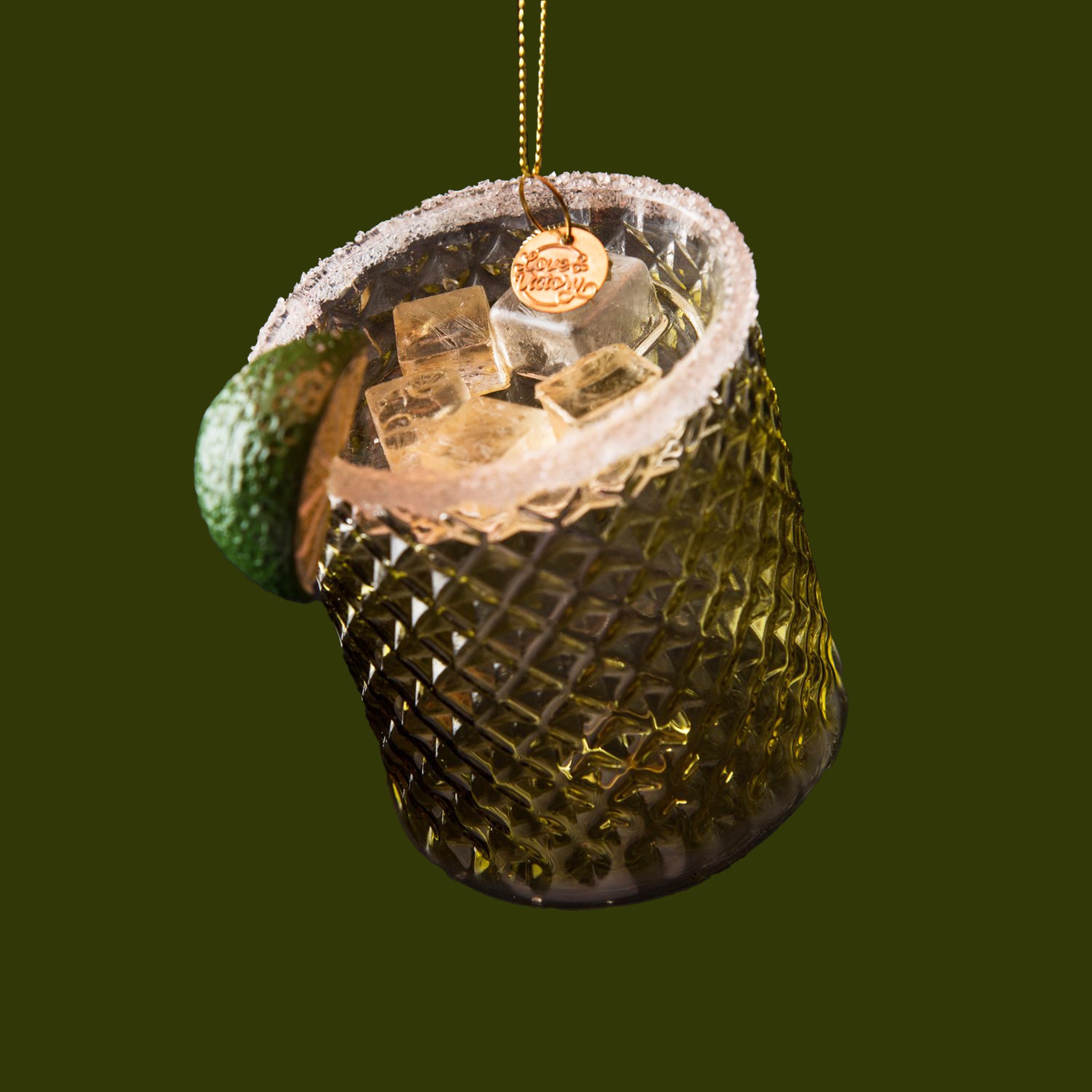 A glass margarita shaped ornament with a salt rim and lime slice. 

