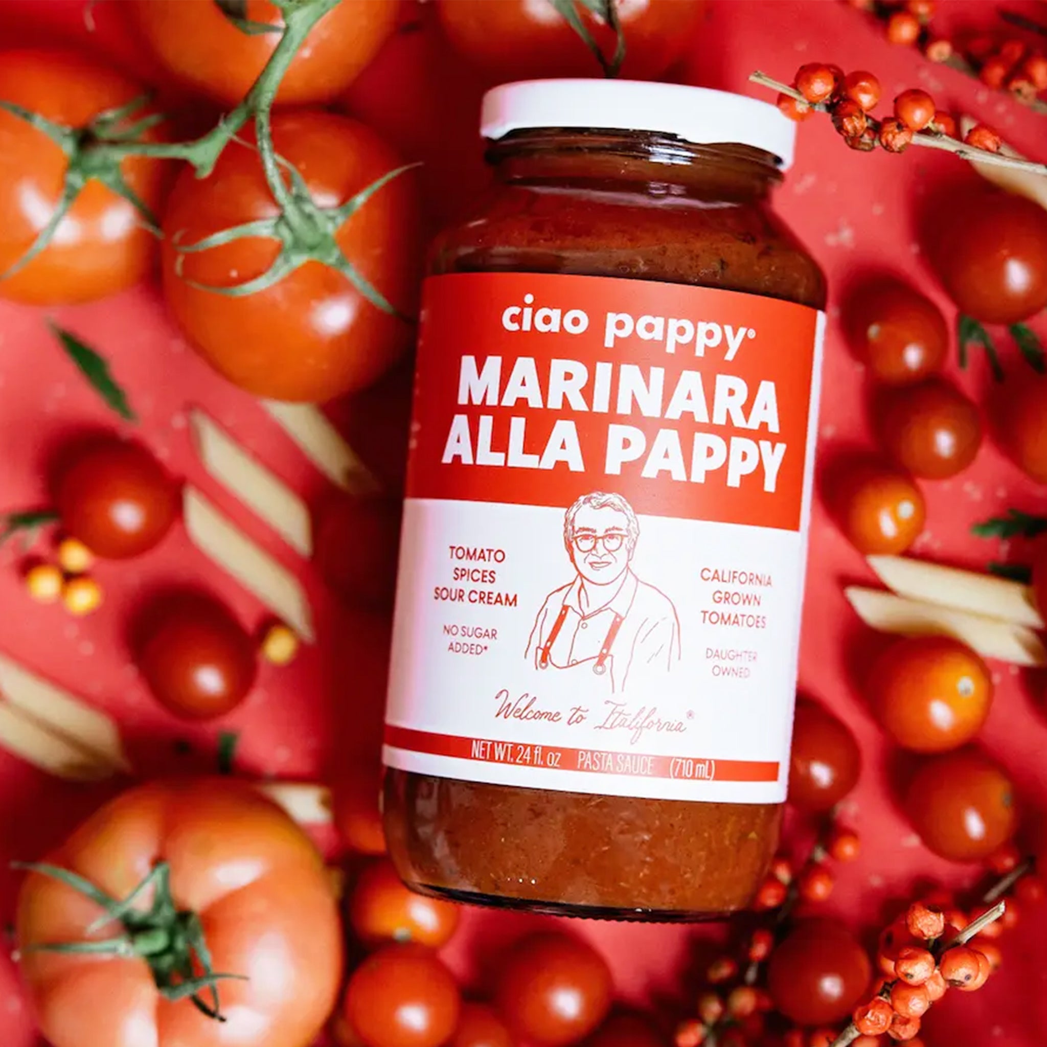 A glass jar of marinara sauce with white text that reads, &#39;ciao pappy Marinara Alla Pappy&#39;. 