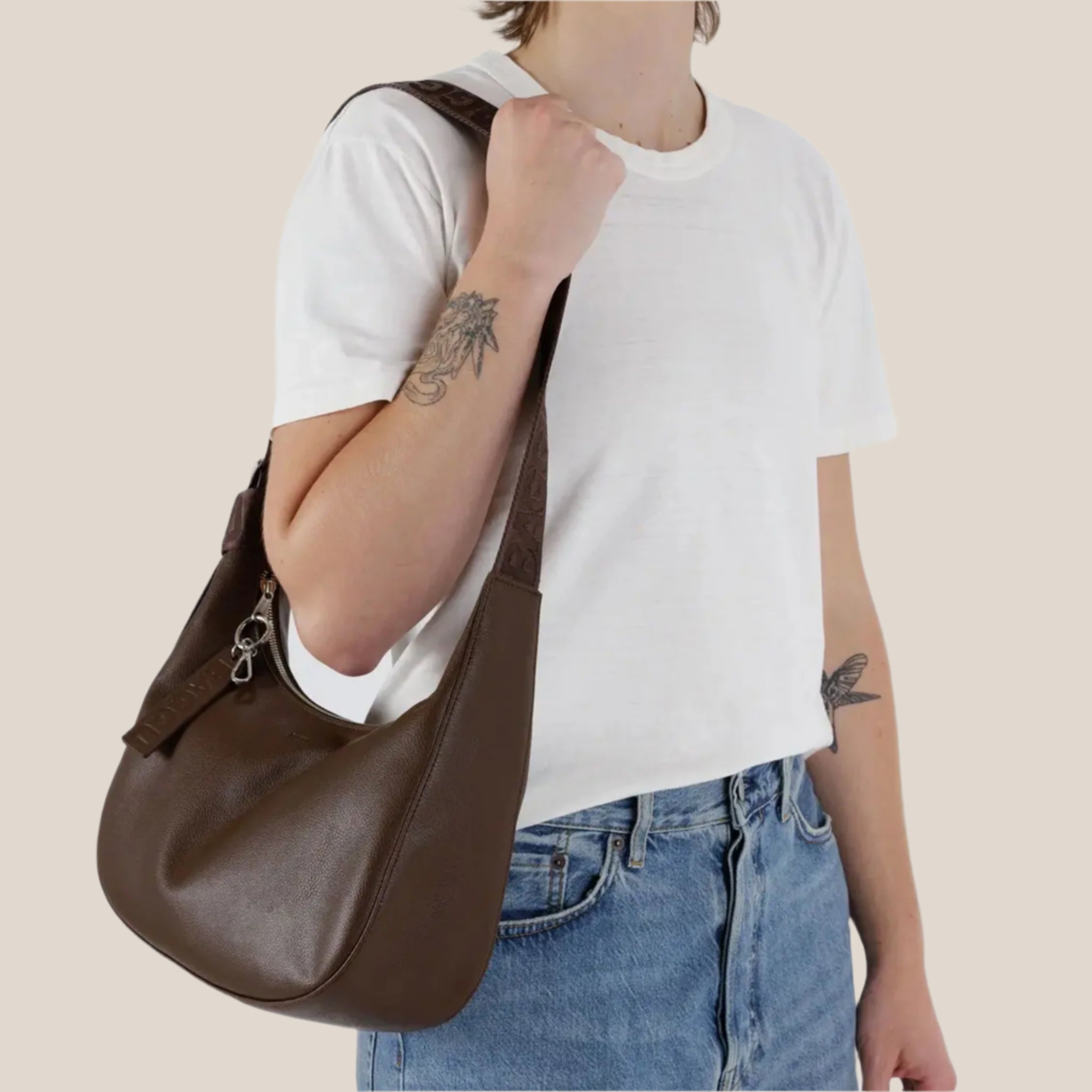 A brown leather crescent bag. 