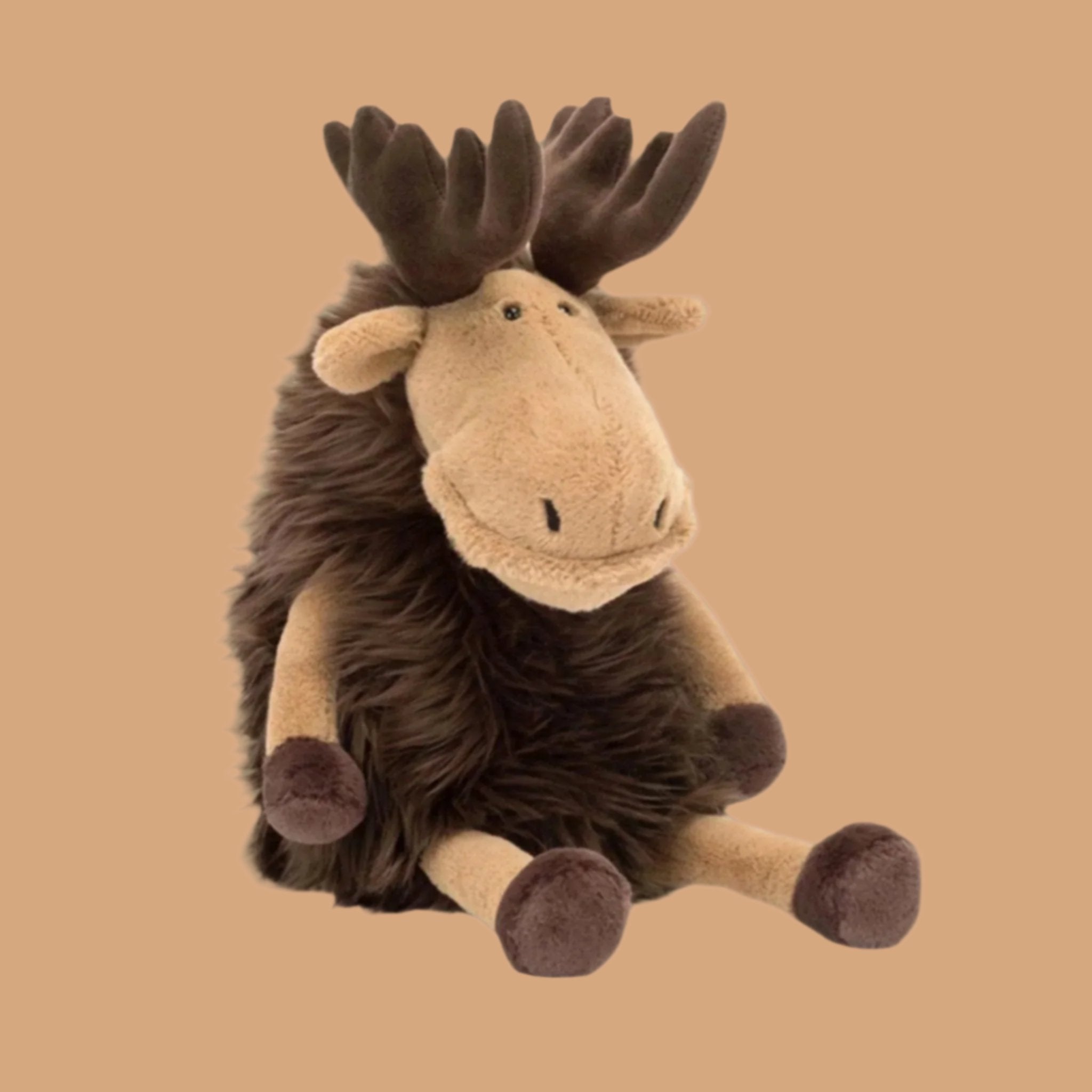 A brown and tan moose shaped stuffed animal. 