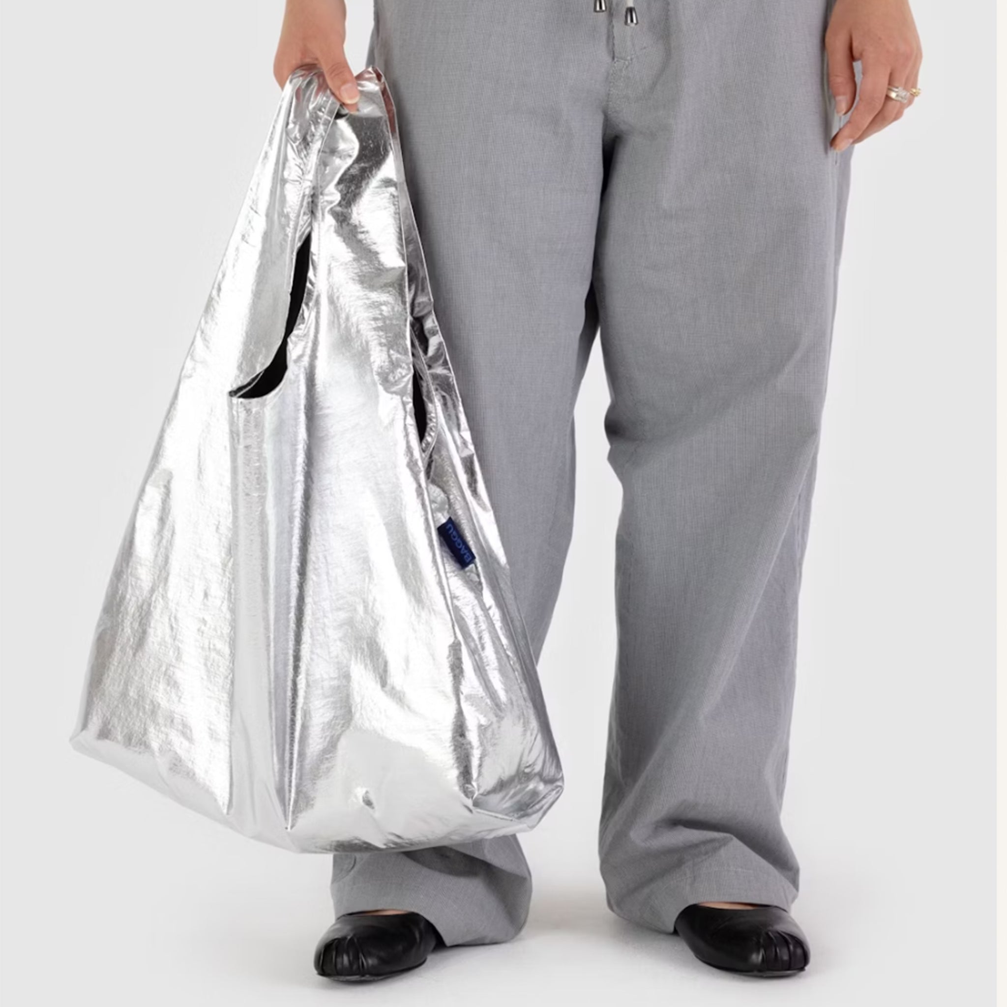 A silver nylon tote bag. 