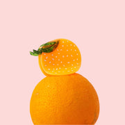 A circle orange shaped claw hair clip. 