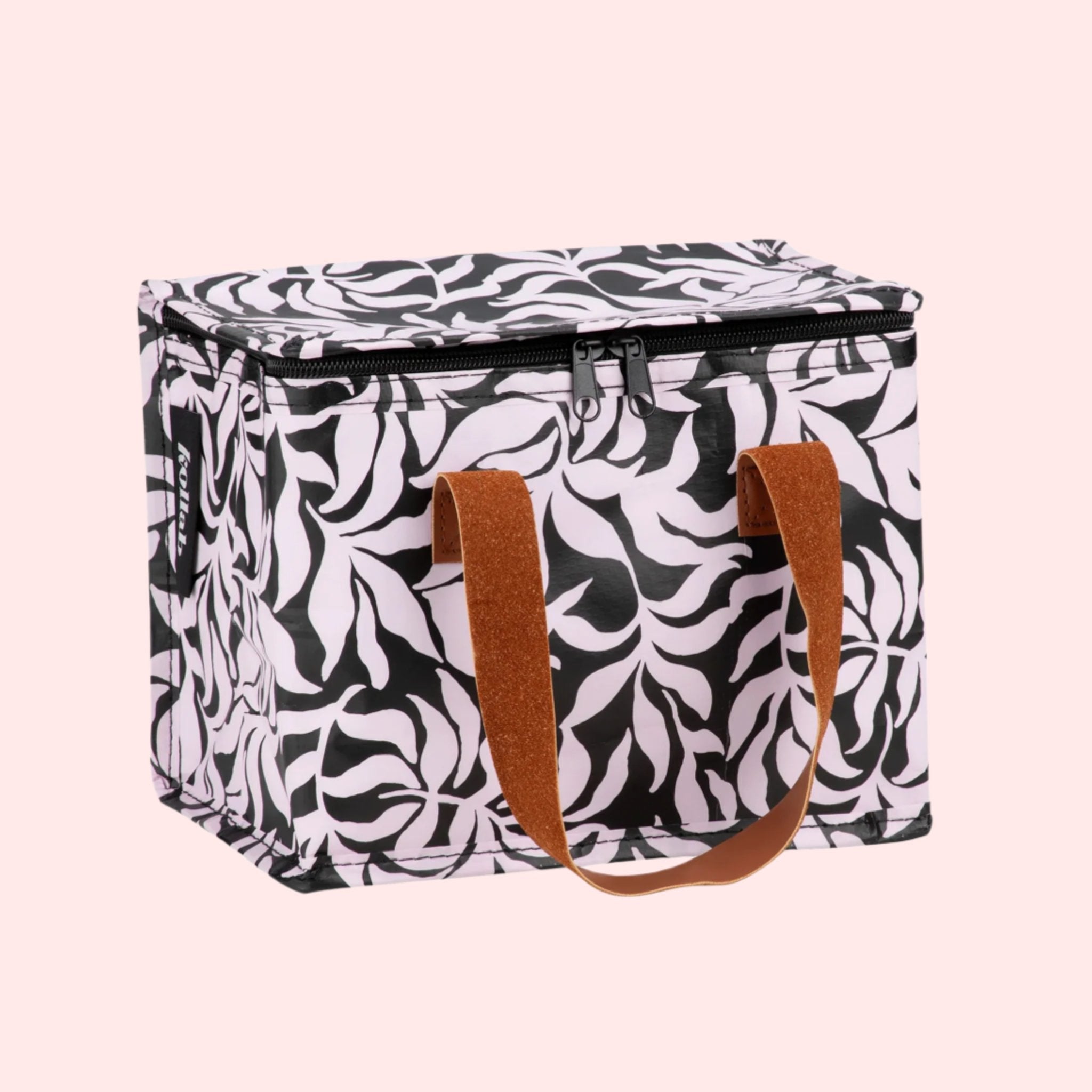 A black and white lunch box with brown leather handles and a zipper closure. 