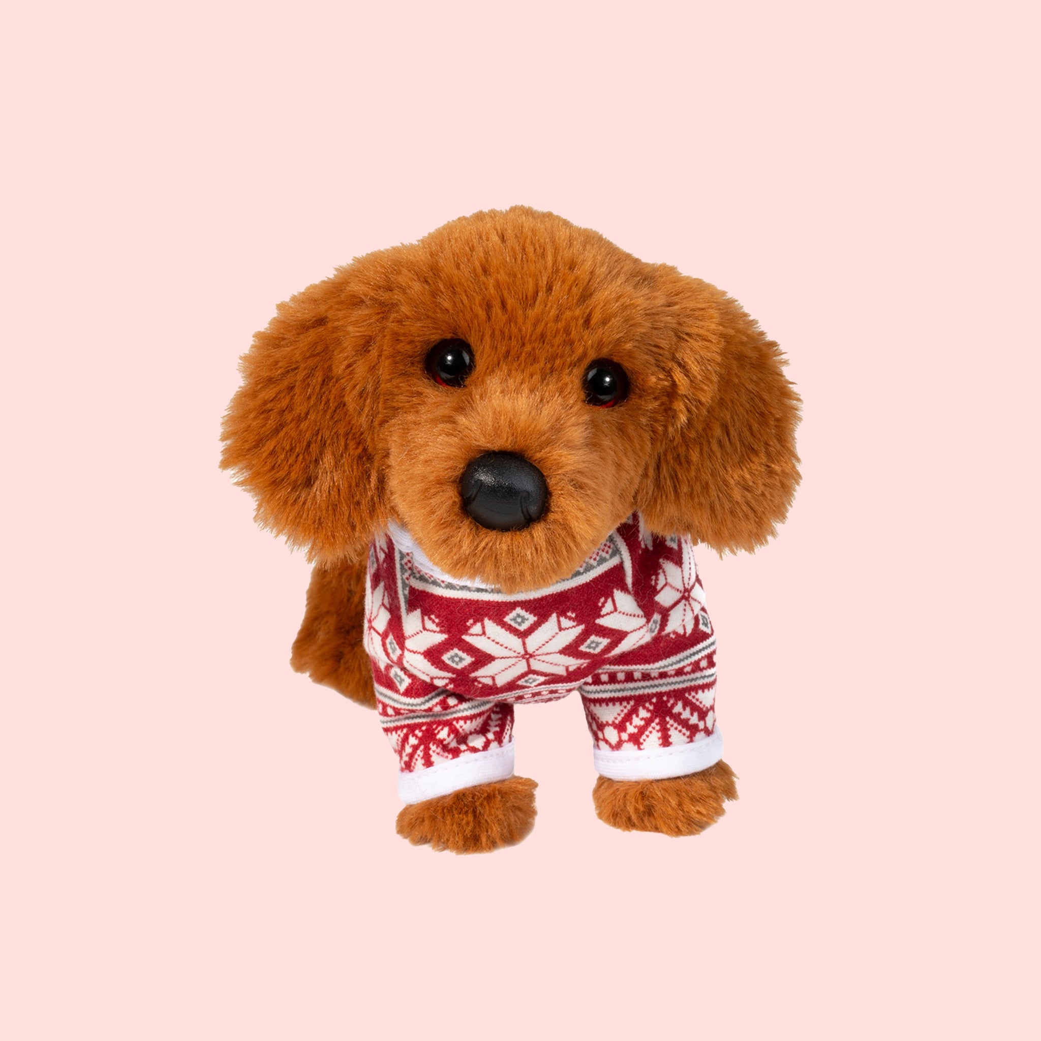 A mini brown dachshund shaped stuffed animal wearing a red and white holiday sweater. 