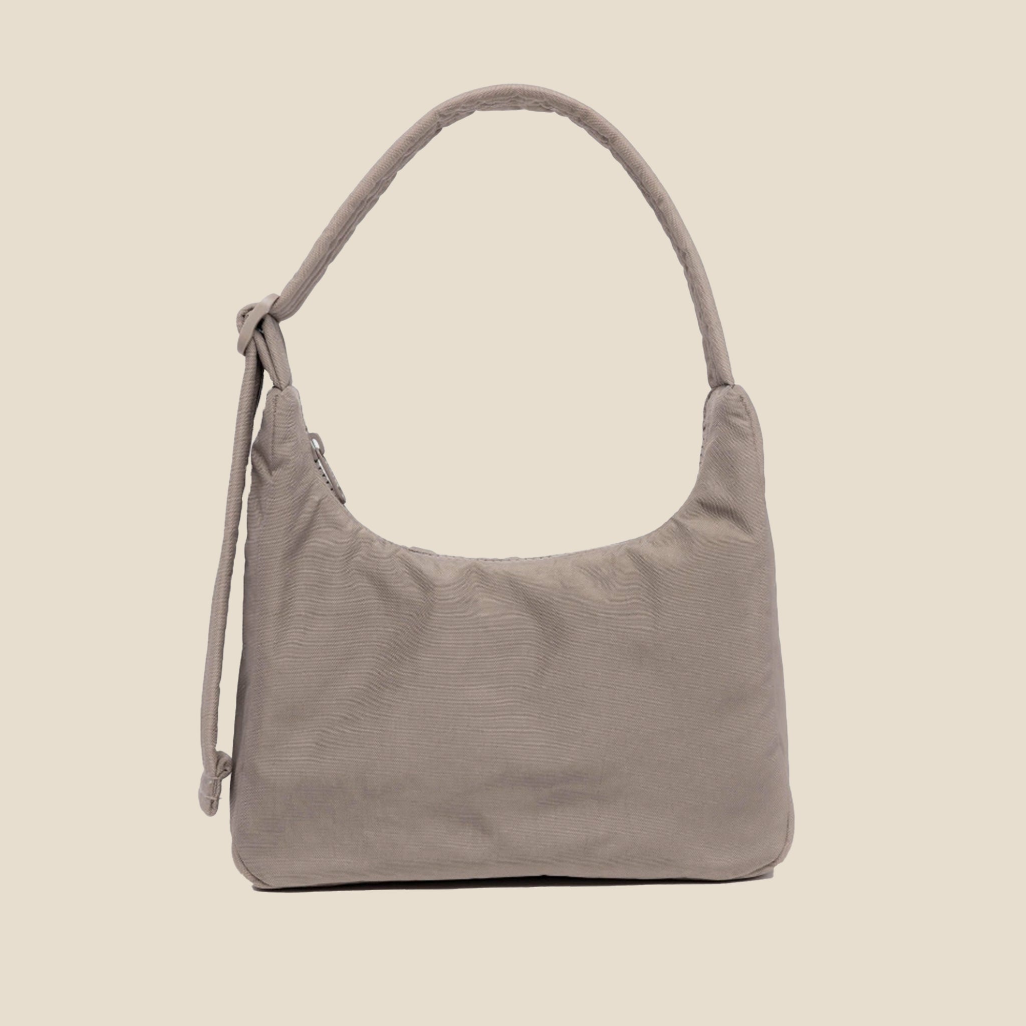 A mini beige / grey nylon shoulder handbag with an adjustable strap. 