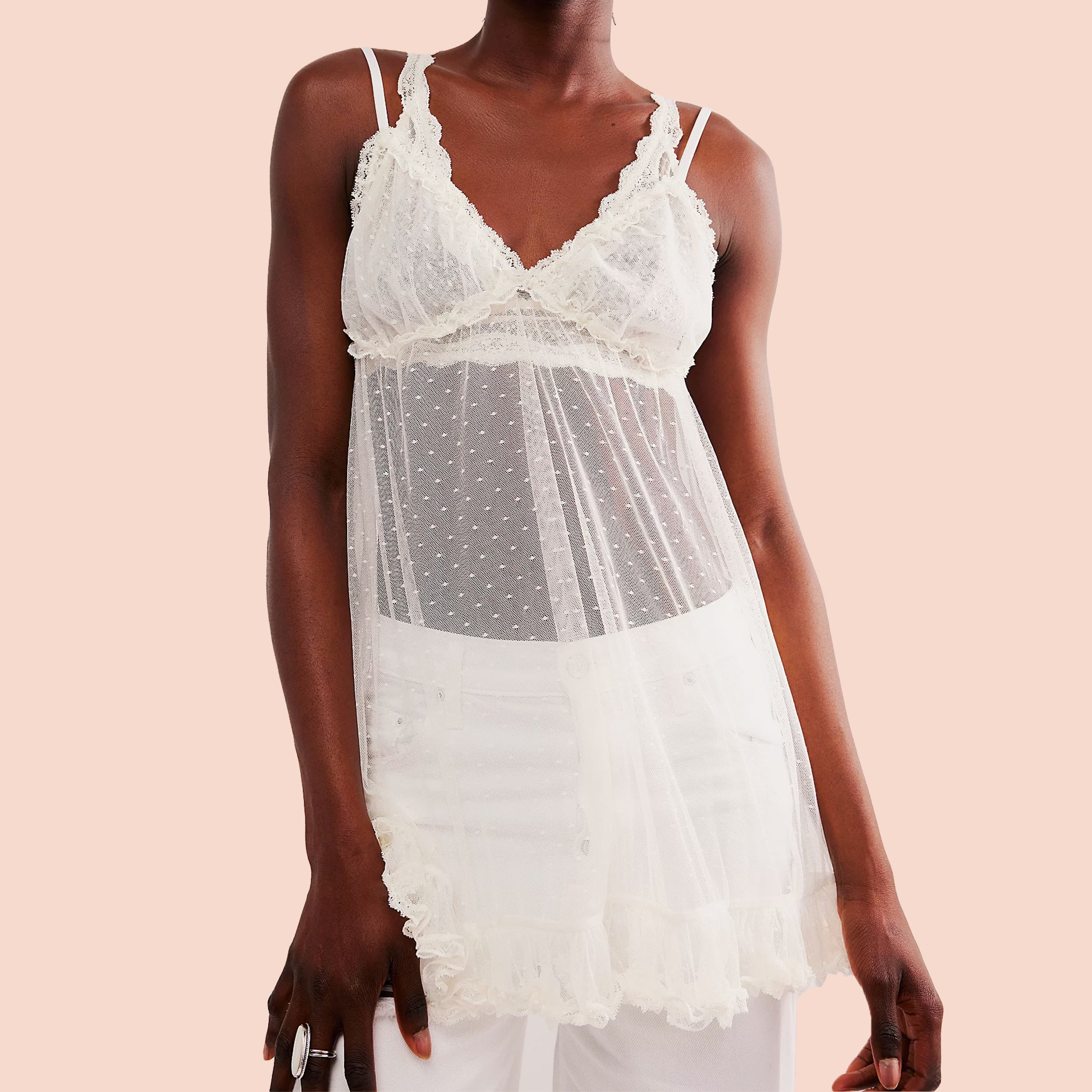 A white mesh slip dress with a polka dot detail. 